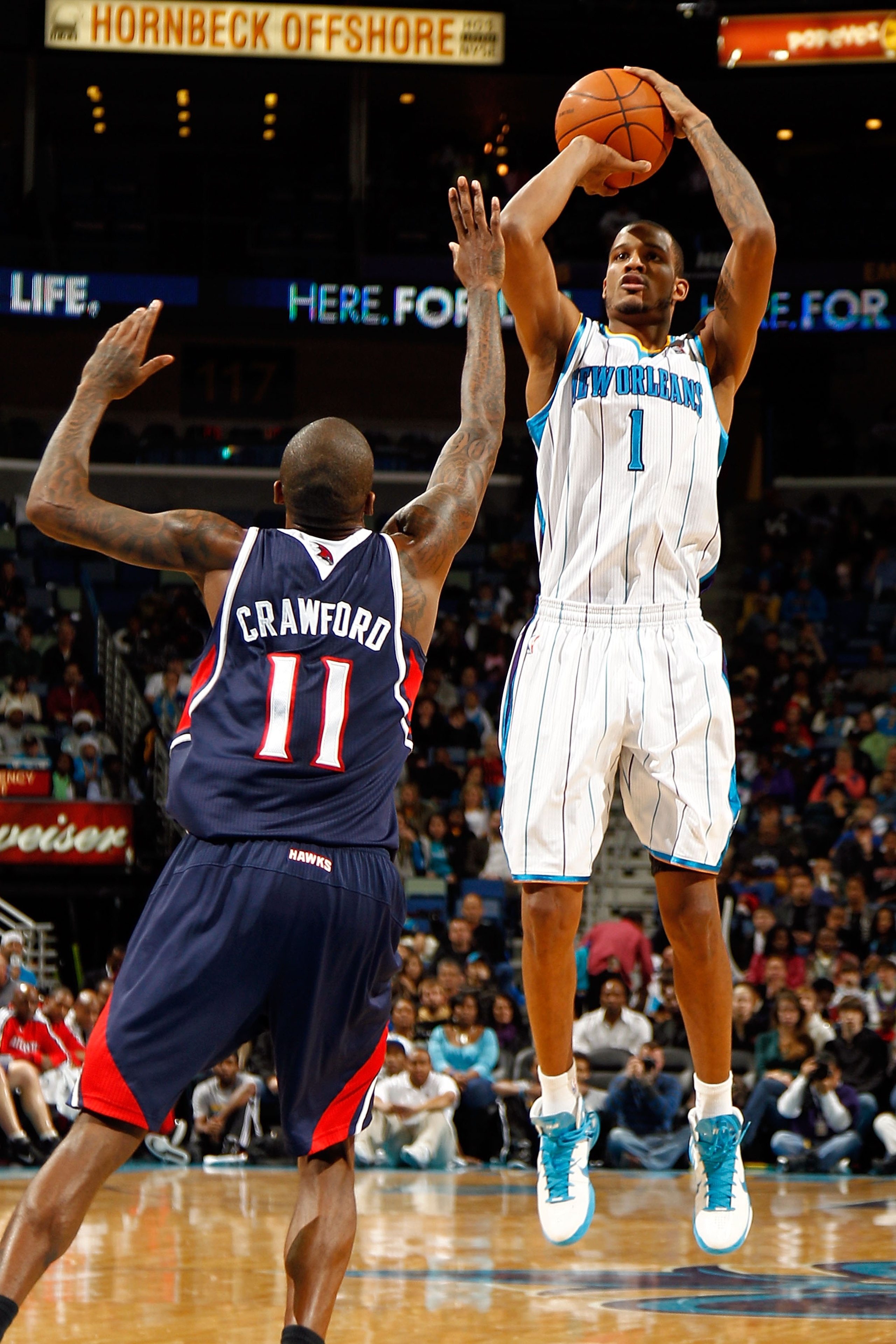 NEW ORLEANS, LA - DECEMBER 26:  Trevor Ariza #1 of the New Orleans Hornets shoots the ball over Jamal Crawford #11 of the Atlanta Hawks at the New Orleans Arena on December 26, 2010 in New Orleans, Louisiana.  NOTE TO USER: User expressly acknowledges and