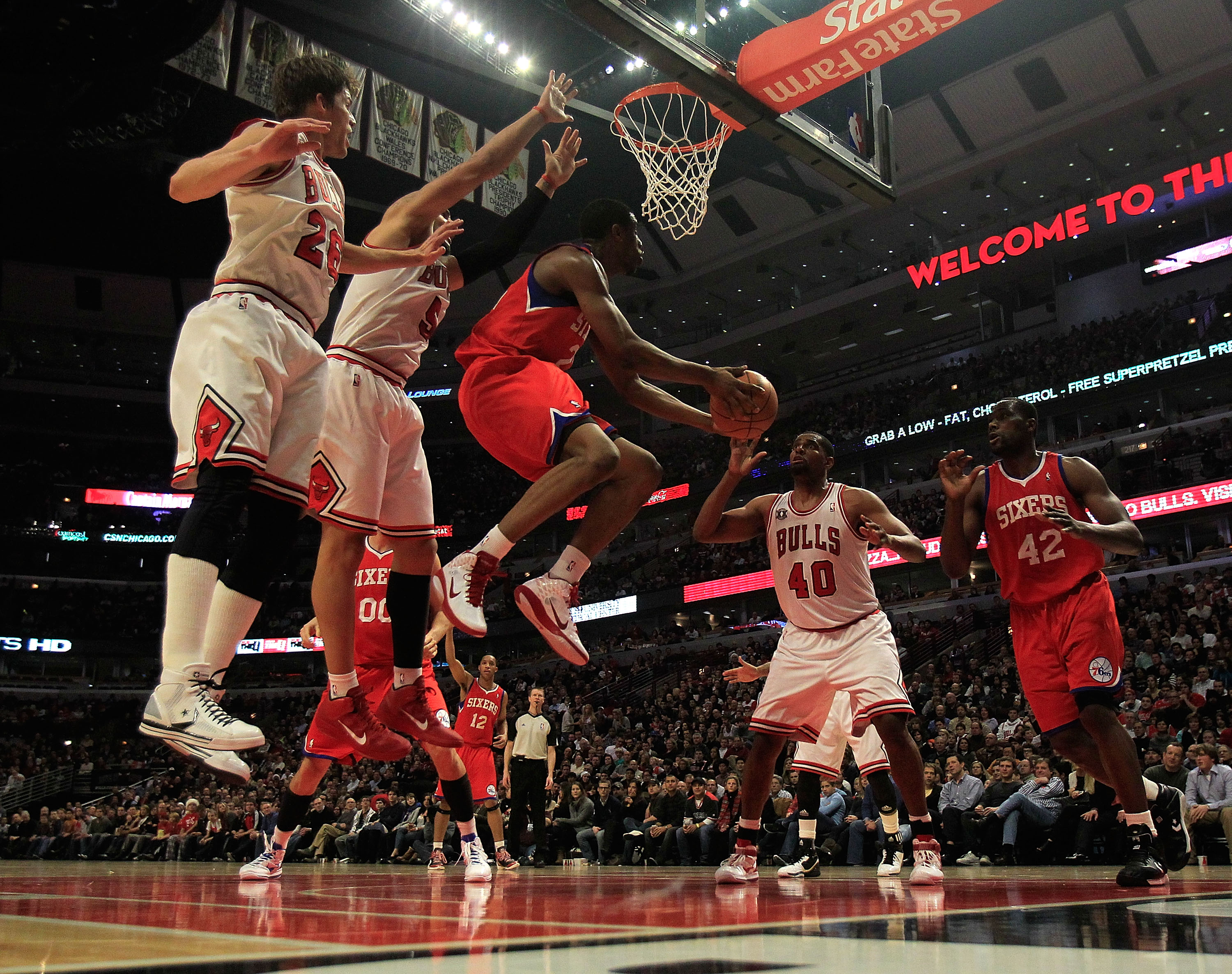 CHICAGO, IL - DECEMBER 21: Thaddeus Young #21 of the Philadelphia 76ers goes up for a shot between (L-R) Kyle Korver #26, Carlos Boozer #5 and Kurt Thomas #40 of the Chicago Bulls and teammate Elton Brand #42 at the United Center on December 21, 2010 in C
