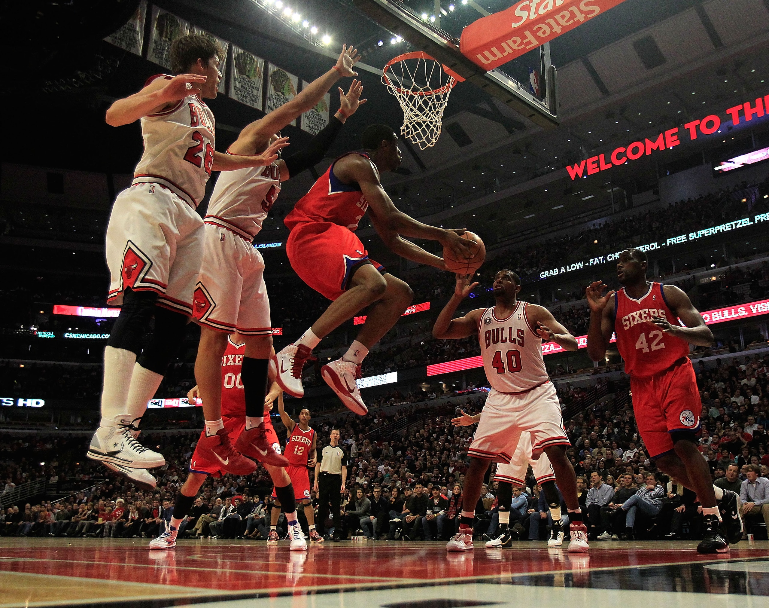 CHICAGO, IL - DECEMBER 21: Thaddeus Young #21 of the Philadelphia 76ers goes up for a shot between (L-R) Kyle Korver #26, Carlos Boozer #5 and Kurt Thomas #40 of the Chicago Bulls and teammate Elton Brand #42 at the United Center on December 21, 2010 in C