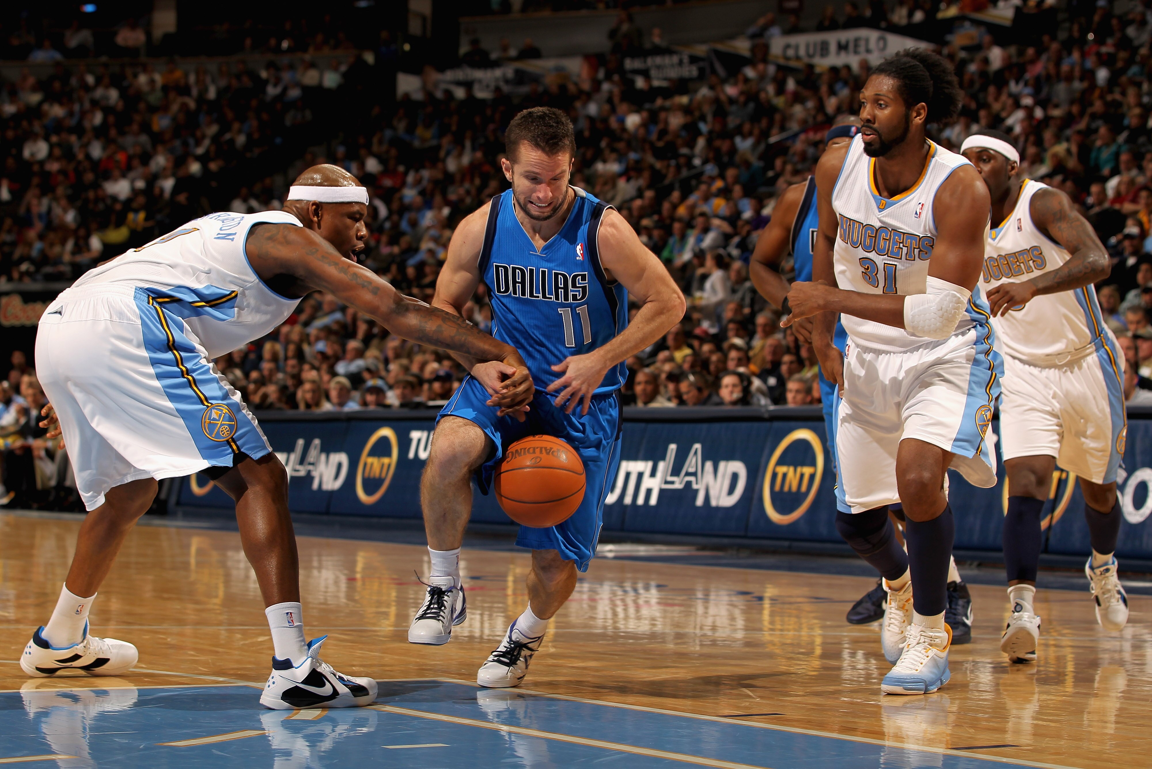 DENVER, CO - FEBRUARY 10:  Jose Barea #11 of the Dallas Mavericks has the ball knocked away by Al Harrington #7 of the Denver Nuggets as Nene #31 follows the play during NBA action at the Pepsi Center on February 10, 2011 in Denver, Colorado. NOTE TO USER