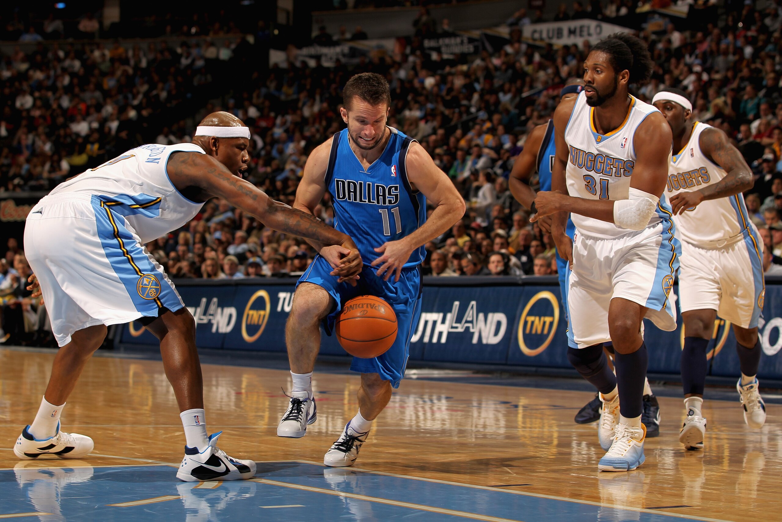 DENVER, CO - FEBRUARY 10:  Jose Barea #11 of the Dallas Mavericks has the ball knocked away by Al Harrington #7 of the Denver Nuggets as Nene #31 follows the play during NBA action at the Pepsi Center on February 10, 2011 in Denver, Colorado. NOTE TO USER