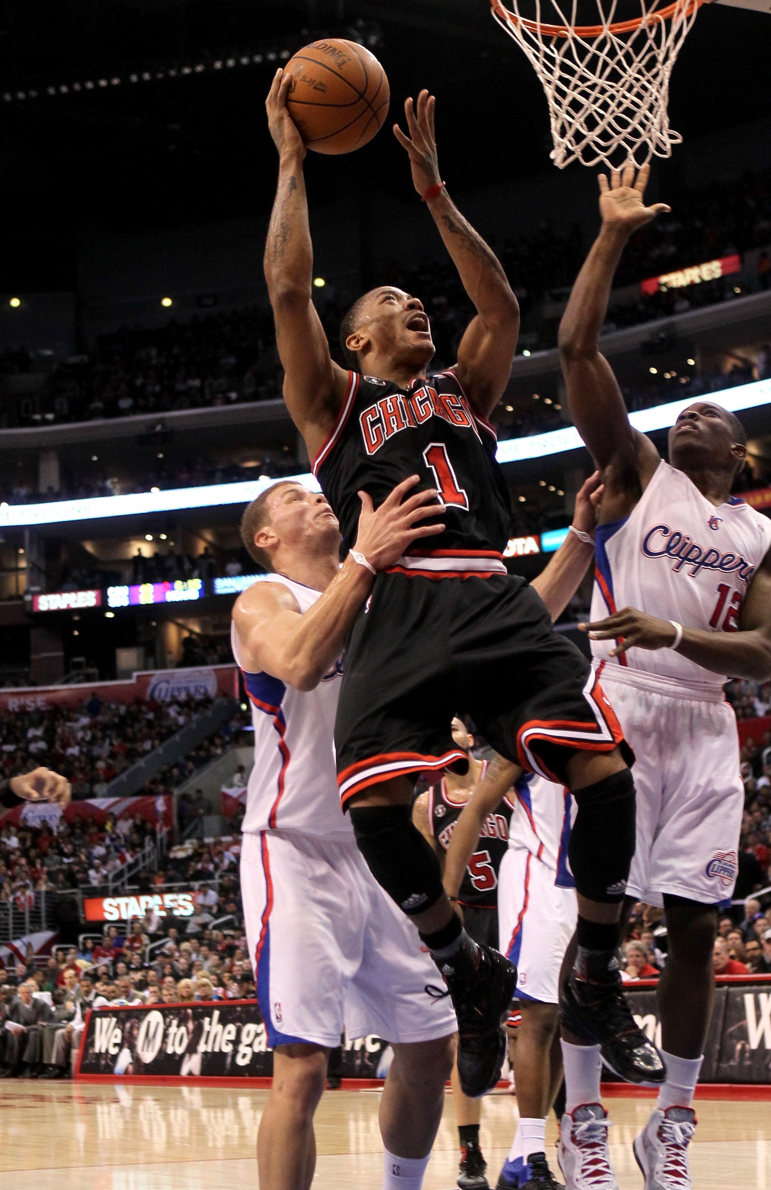LOS ANGELES, CA - FEBRUARY 02:  Derrick Rose #1 of the Chicago Bulls goes up for a shot over Blake Griffin #32 and Eric Bledsoe #12 of the Los Angeles Clippers at Staples Center on February 2, 2011  in Los Angeles, California.  NOTE TO USER: User expressl
