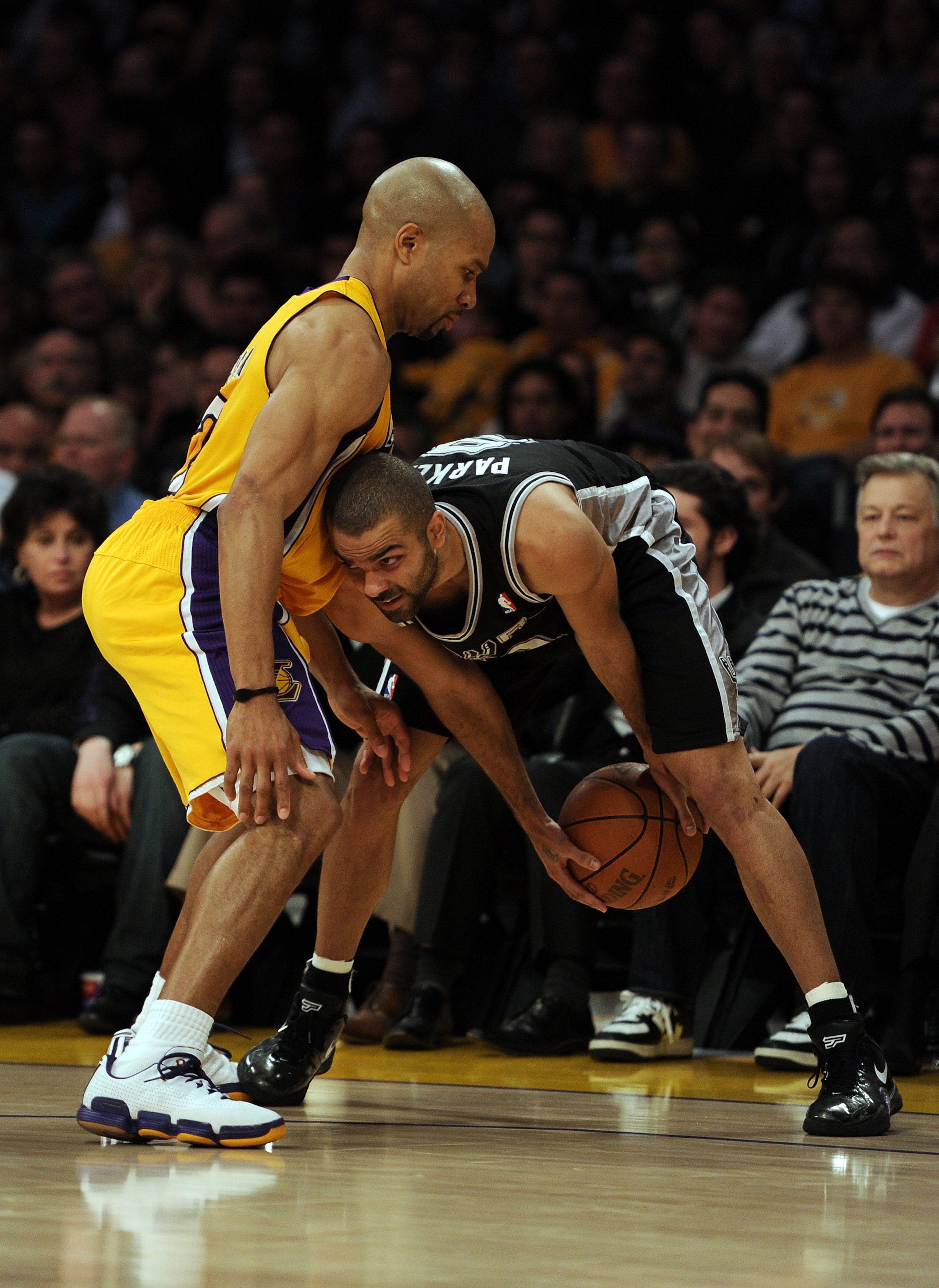 LOS ANGELES, CA - FEBRUARY 03:  Tony Parker #9 of the San Antonio Spurs is guarded by Derek Fisher #2 of the Los Angeles Lakers at Staples Center on February 3, 2011 in Los Angeles, California.  NOTE TO USER: User expressly acknowledges and agrees that, b