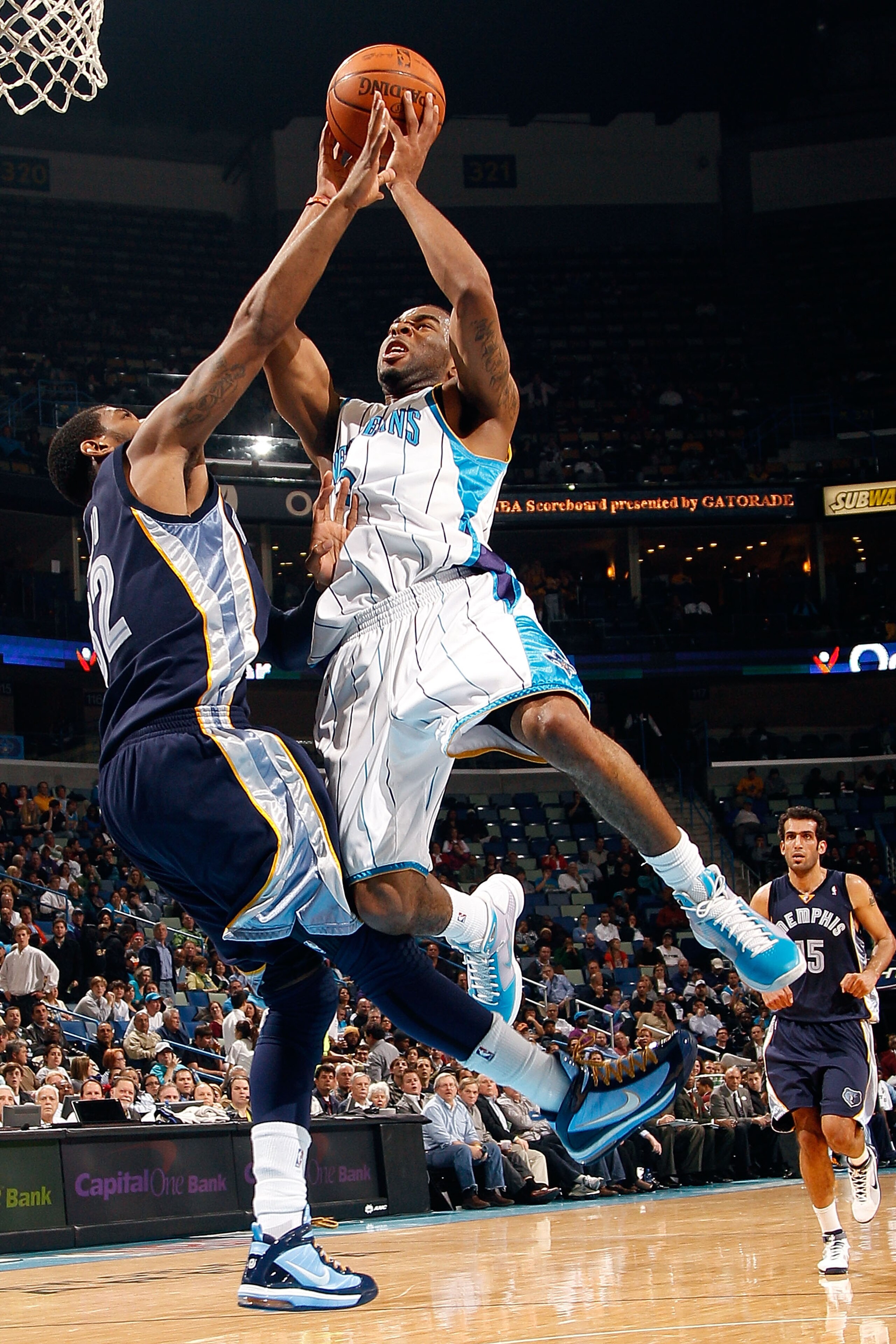 NEW ORLEANS - MARCH 03:  Marcus Thornton #5 of the New Orleans Hornets makes a shot over O.J. Mayo #32 of the Memphis Grizzlies at the New Orleans Arena on March 3, 2010 in New Orleans, Louisiana.  NOTE TO USER: User expressly acknowledges and agrees that