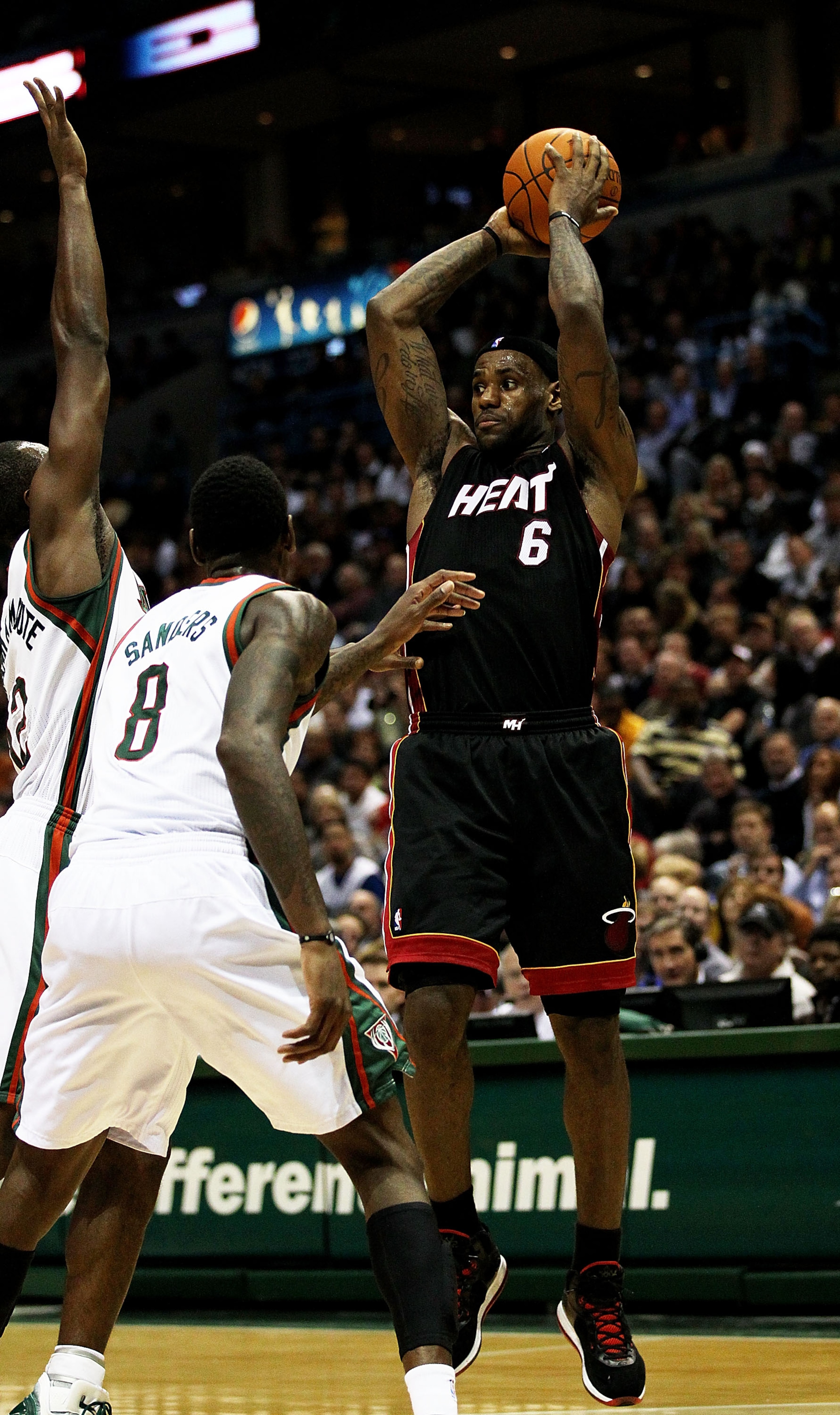 MILWAUKEE, WI - DECEMBER 06: LeBron James #6 of the Miami Heat leaps to pass over Corey Maggette #5 and Larry Sanders #8 of the Milwaukee Bucks at the Bradley Center on December 6, 2010 in Milwaukee, Wisconsin. The Heat defeated the Bucks 88-78. NOTE TO U