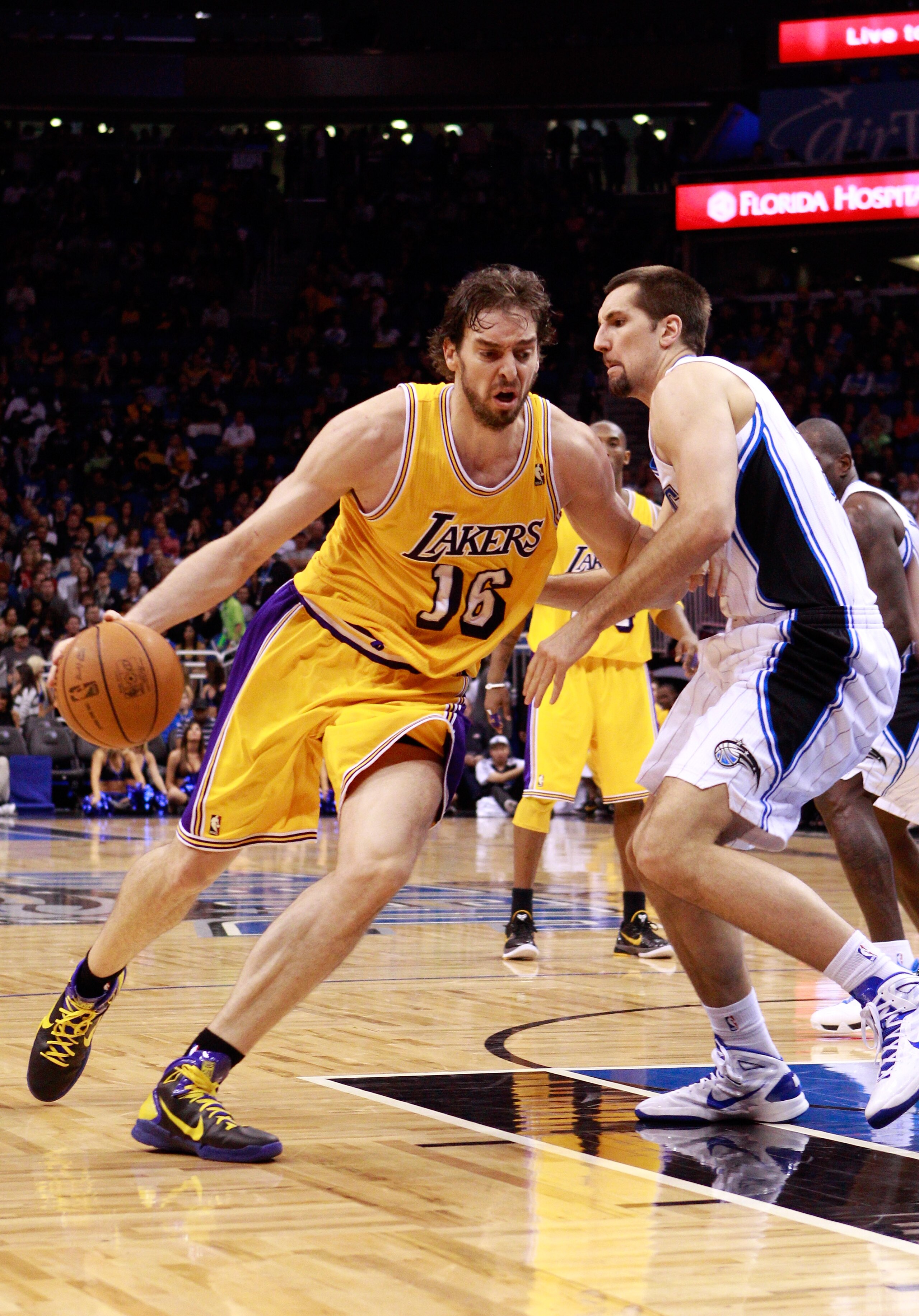 ORLANDO, FL - FEBRUARY 13:  Pau Gasol #16 of the Los Angeles Lakers drives against Ryan Anderson #33 of the Orlando Magic during the game at Amway Arena on February 13, 2011 in Orlando, Florida.  NOTE TO USER: User expressly acknowledges and agrees that,