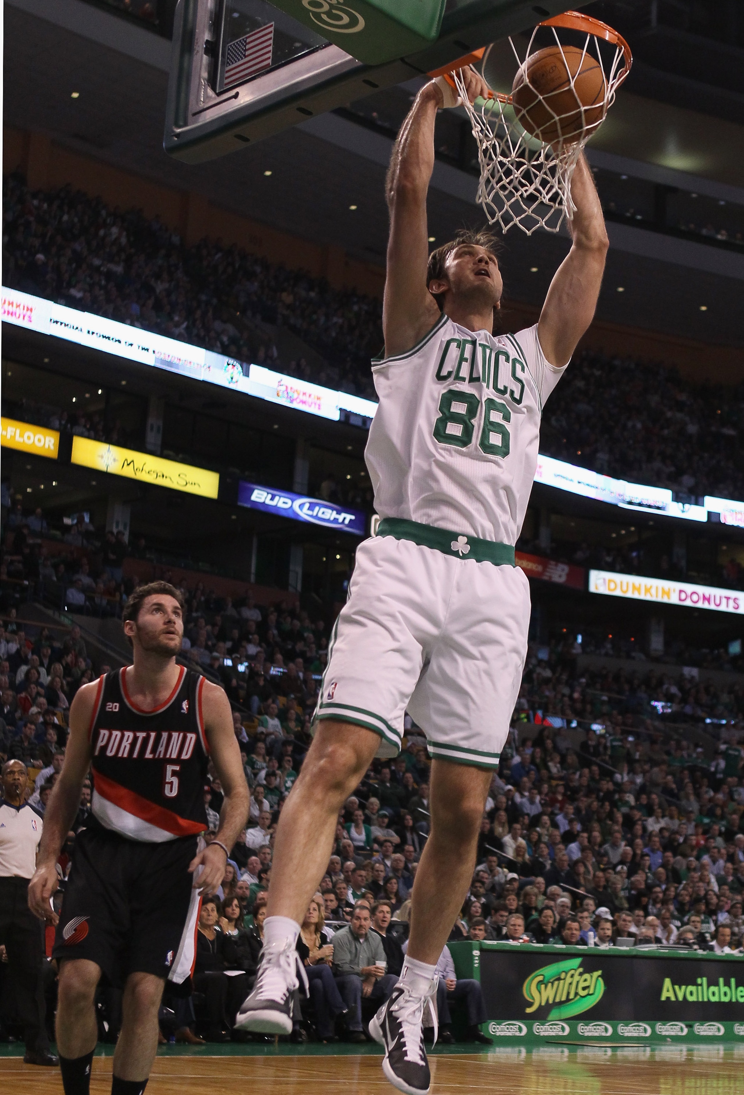 BOSTON - DECEMBER 01:  Semih Erden #86 of the Boston Celtics dunks the ball as Rudy Fernandez #5 of the Portland Trailblazers defends on December 1, 2010 at the TD Garden in Boston, Massachusetts.  NOTE TO USER: User expressly acknowledges and agrees that