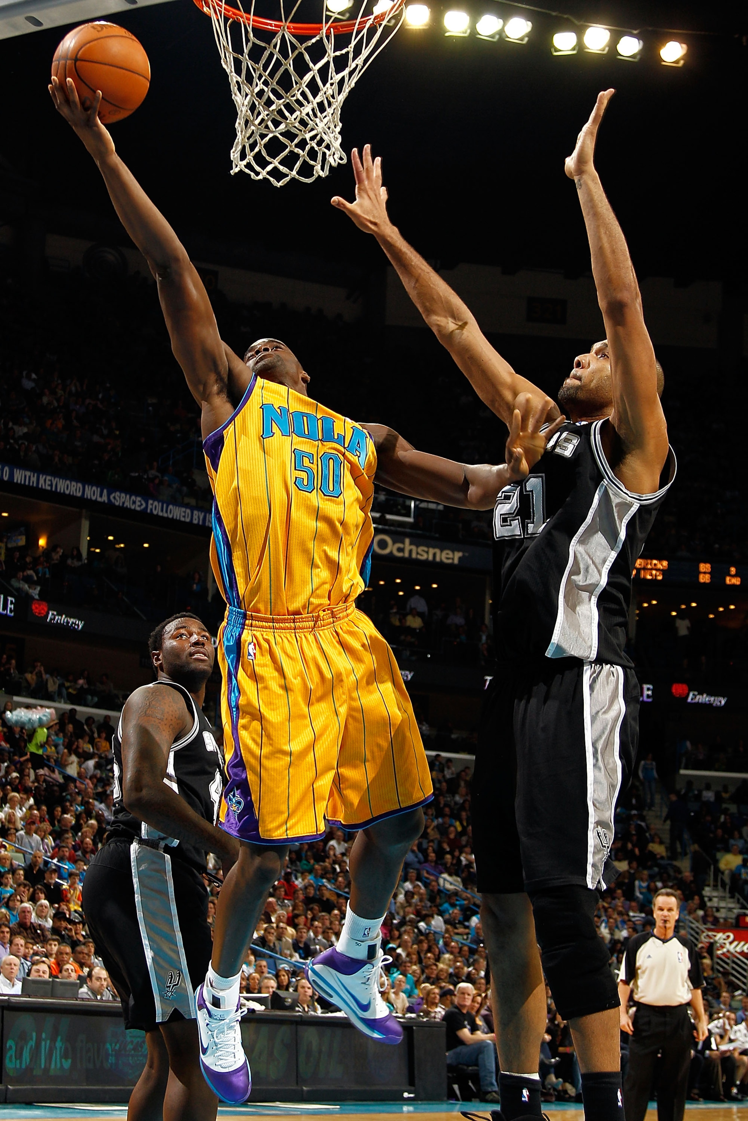 NEW ORLEANS, LA - JANUARY 22:  Emeka Okafor #50 of the New Orleans Hornets shoots the ball over Tim Duncan #21 of the San Antonio Spurs at the New Orleans Arena on January 22, 2011 in New Orleans, Louisiana.  NOTE TO USER: User expressly acknowledges and