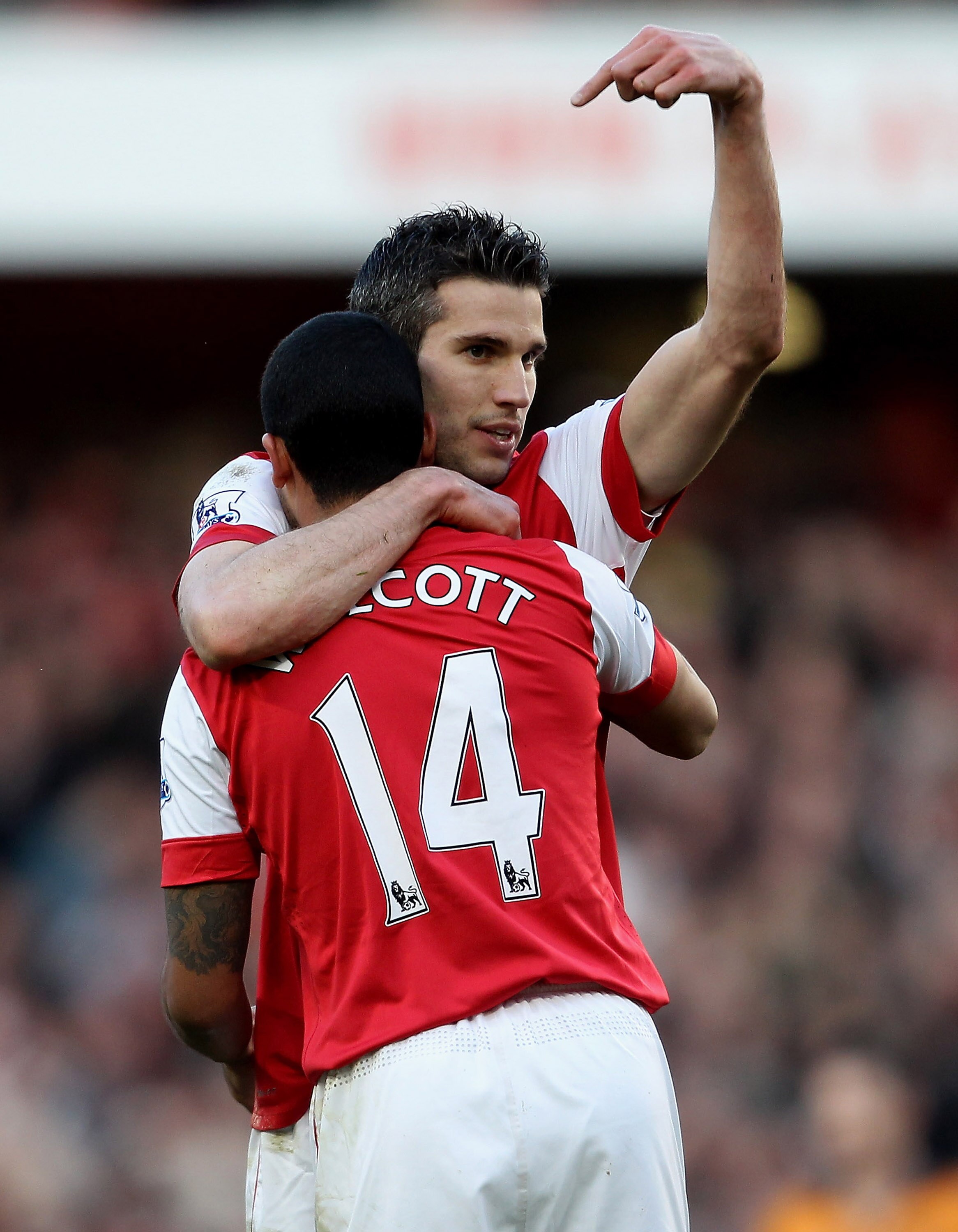 LONDON, ENGLAND - FEBRUARY 12: Robin Van Persie of Arsenal celebrates with Theo Walcott after scoring their second goal during the Barclays Premier League match between Arsenal and Wolverhampton Wanderers on February 12, 2011 in London, England.  (Photo b
