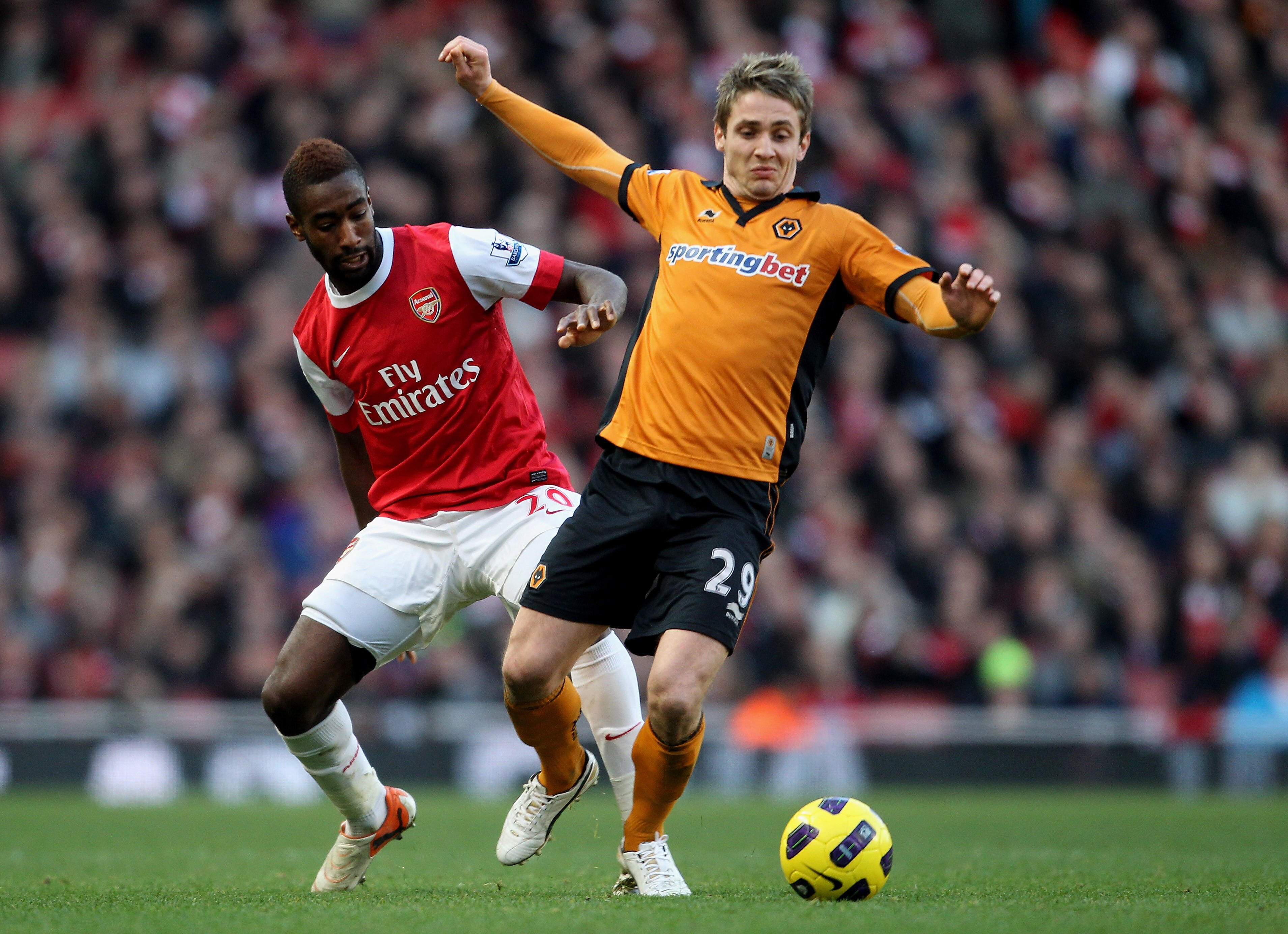 LONDON, ENGLAND - FEBRUARY 12:  Kevin Doyle of Wolves (R) in action with Johan Djourou of Arsenal during the Barclays Premier League match between Arsenal and Wolverhampton Wanderers on February 12, 2011 in London, England.  (Photo by Scott Heavey/Getty I