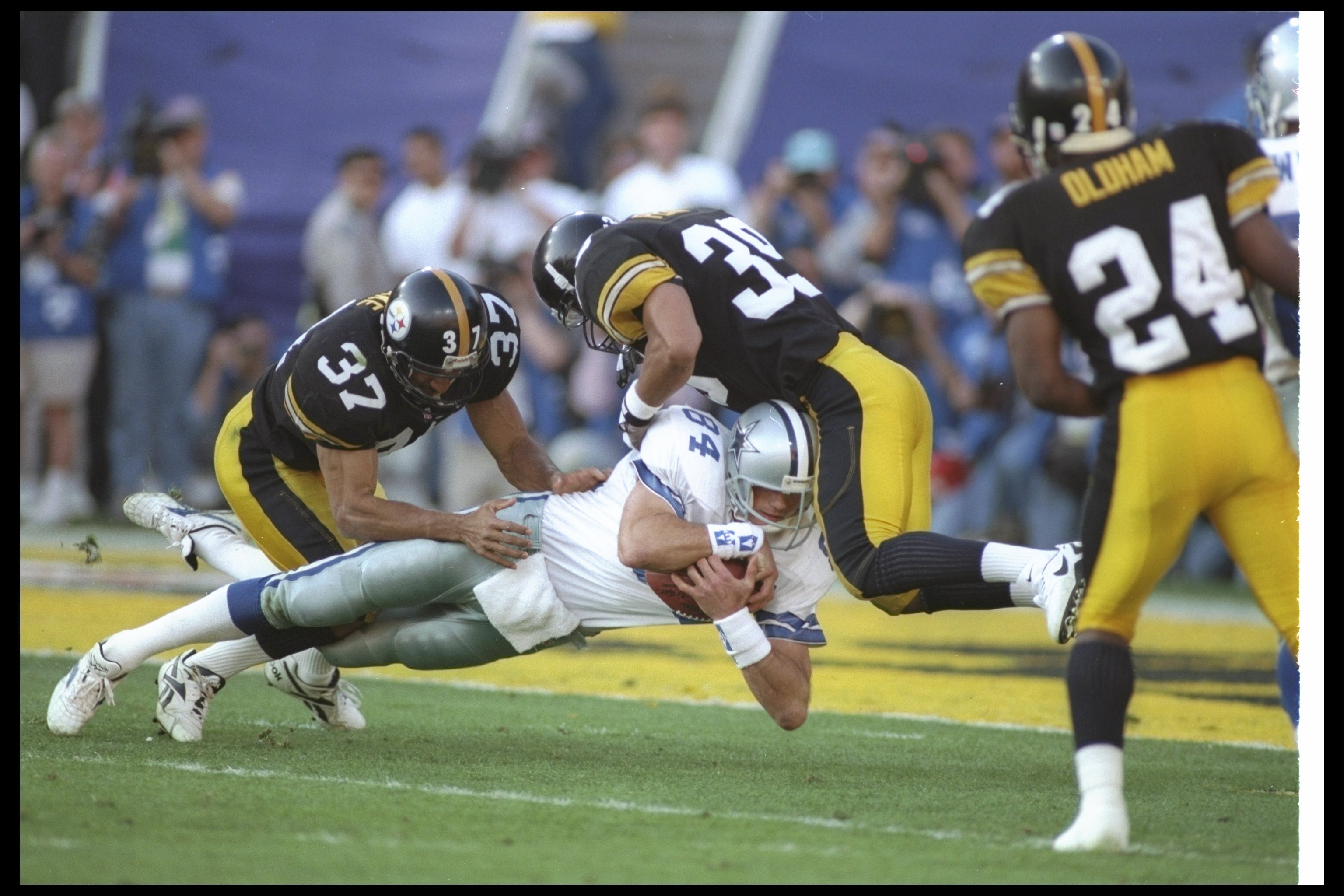 28 Jan 1996:  Tight end Jay Novacek of the Dallas Cowboys gets tackled by Pittsburgh Steelers defensive backs Carnell Lake (left) and Darren Perry during Super Bowl XXX at Sun Devil Stadium in Tempe, Arizona.  The Cowboys won the game, 27-17. Mandatory Cr