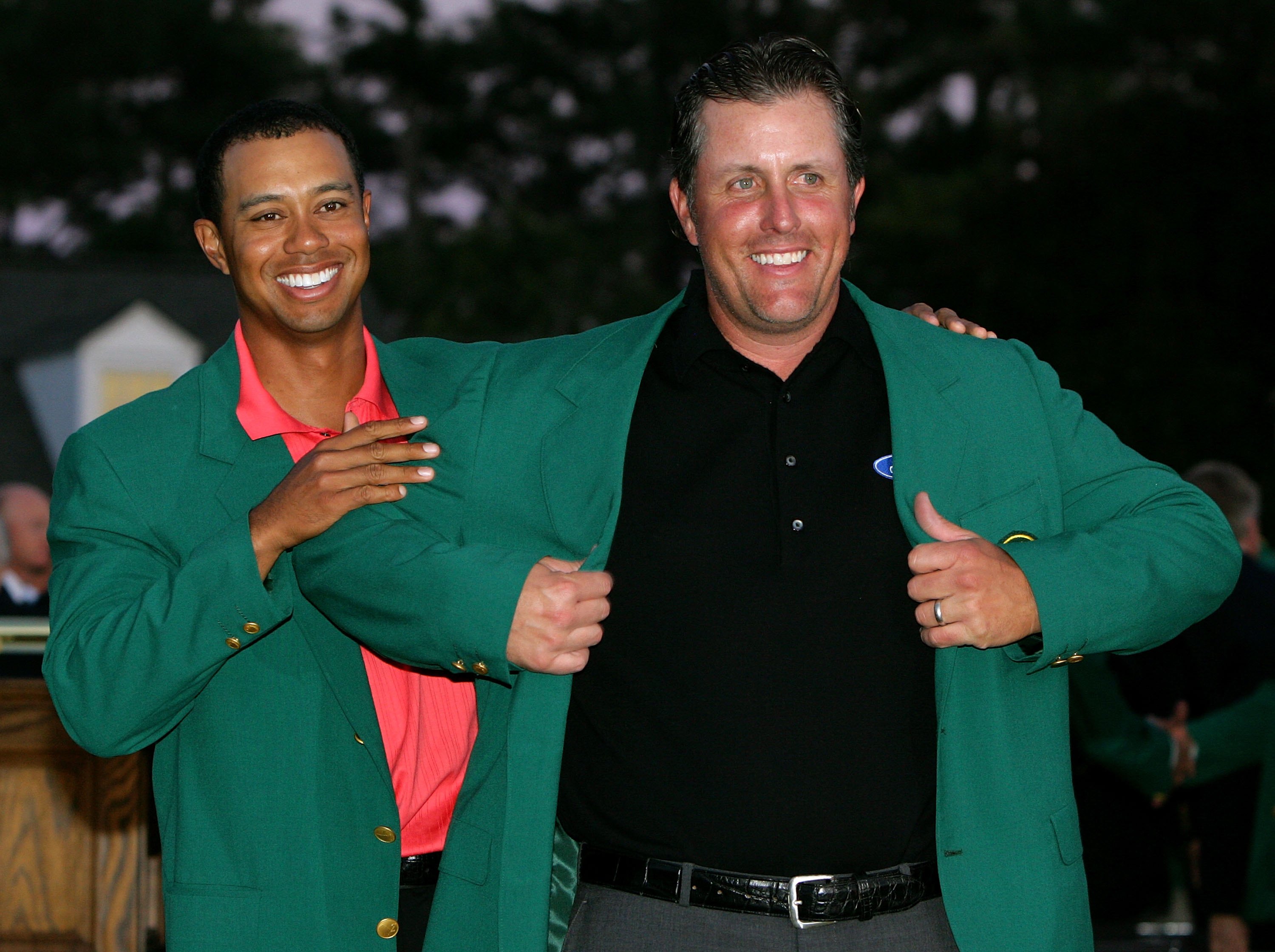 AUGUSTA, GA - APRIL 09:  Tiger Woods puts the green jacket on Phil Mickelson after he won The Masters at the Augusta National Golf Club after the final round on April 9, 2006 in Augusta, Georgia.   Mickelson won with the score seven under.  (Photo by Davi