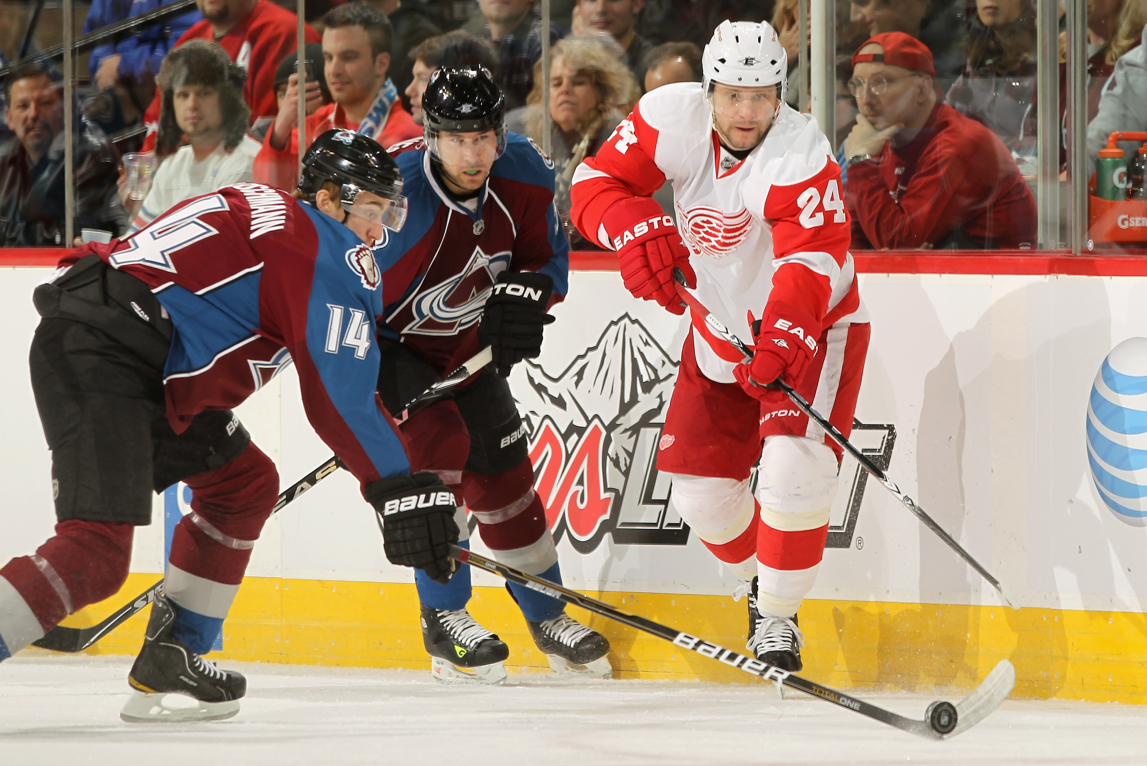 DENVER, CO - JANUARY 10:  Ruslan Salei #24 of the Detroit Red Wings passes the puck past Tomas Fleischmann #14 of the Colorado Avalanche at the Pepsi Center on January 10, 2011 in Denver, Colorado.  (Photo by Doug Pensinger/Getty Images)