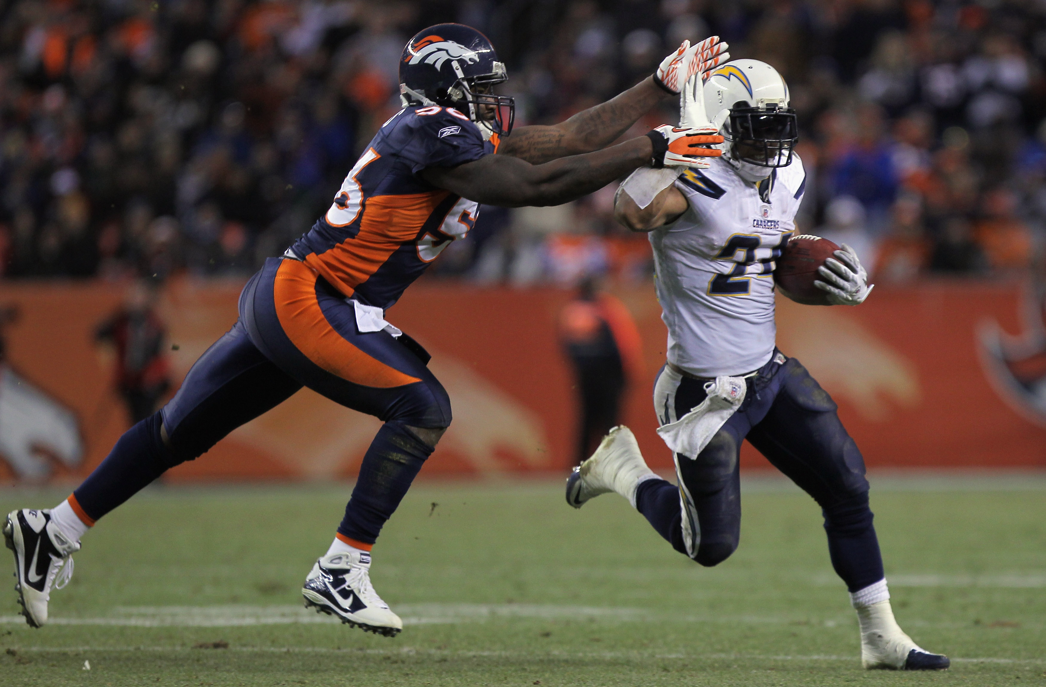 DENVER - JANUARY 02:  Running back Ryan Mathews #24 of the San Diego Chargers eludes linebacker Robert Ayers #56 of the Denver Broncos as he rushes for a 31 yard touchdown on fourth down and one yard to go in the fourth quarter at INVESCO Field at Mile Hi
