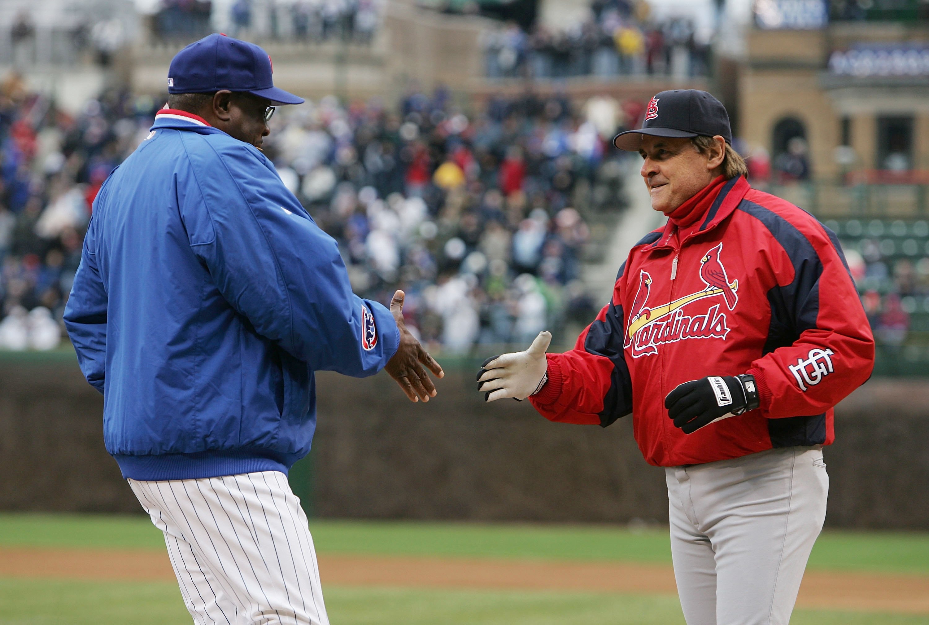 CHICAGO - APRIL 07:  Maqnager Dusty Baker of the Chicago Cubs shakes hands with Manager Tony LaRussa of the St. Louis Cardinals before the Opening Day game on April 7, 2006 at Wrigley Field in Chicago, Illinois. The Cubs defeated the Cardinals 5-1.  (Phot