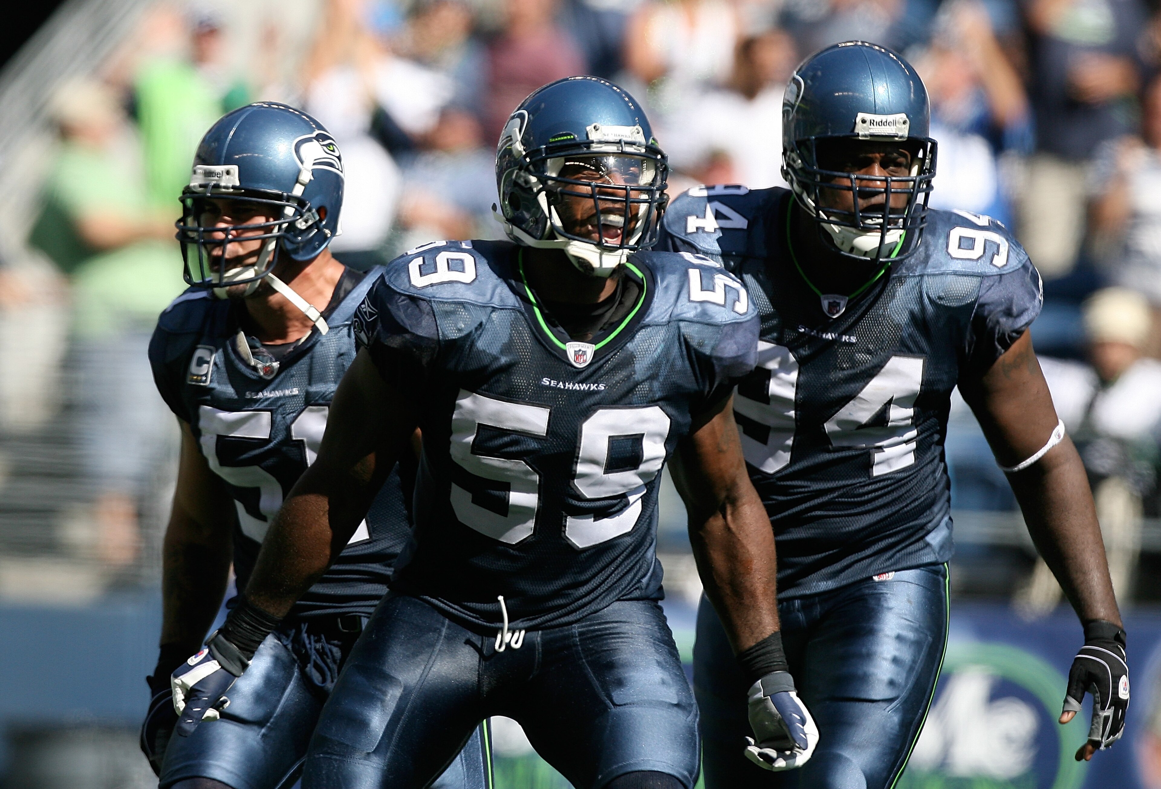 SEATTLE - SEPTEMBER 13:  Linebacker Aaron Curry #59 of the Seattle Seahawks, celebrates with teammates Lofa Tatupu #51 and Cory Redding #94 after sacking quarterback Marc Bulger #10 of the St. Louis Rams on September 13, 2009 at Qwest Field in Seattle, Wa