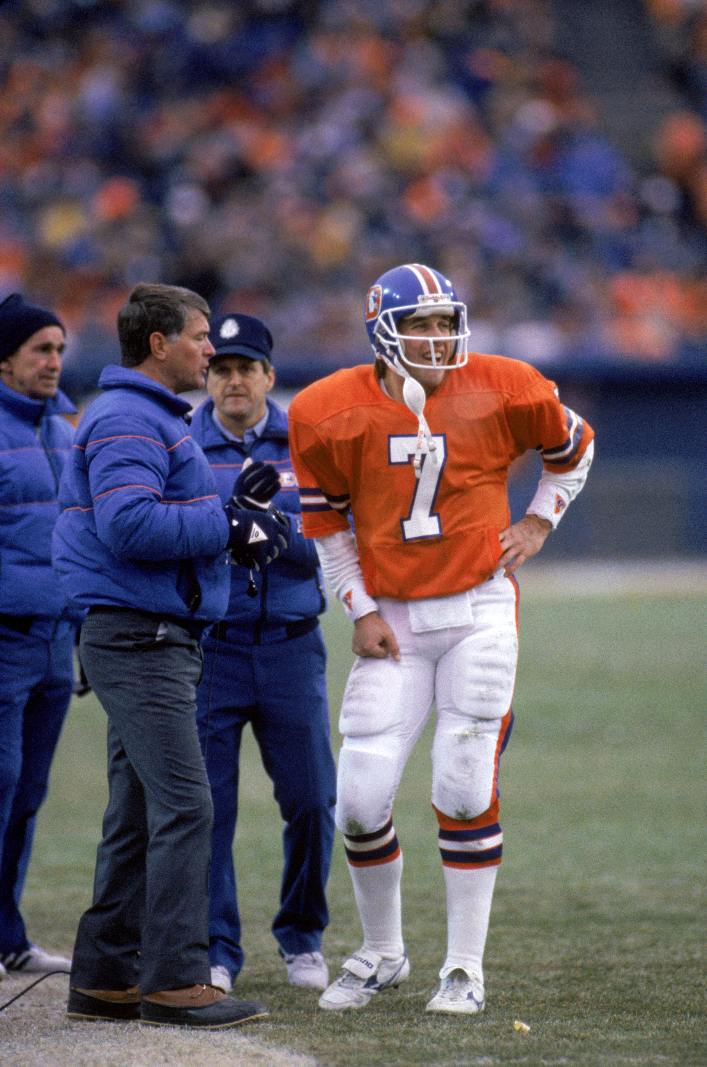 DENVER - DECEMBER 8:  Head coach Dan Reeves talks with quarterback John Elway #7 of the Denver Broncos on the sidelines during a game against the Los Angeles Raiders at Mile High Stadium on December 8, 1985 in Denver, Colorado.  The Raiders won 17-14 in o