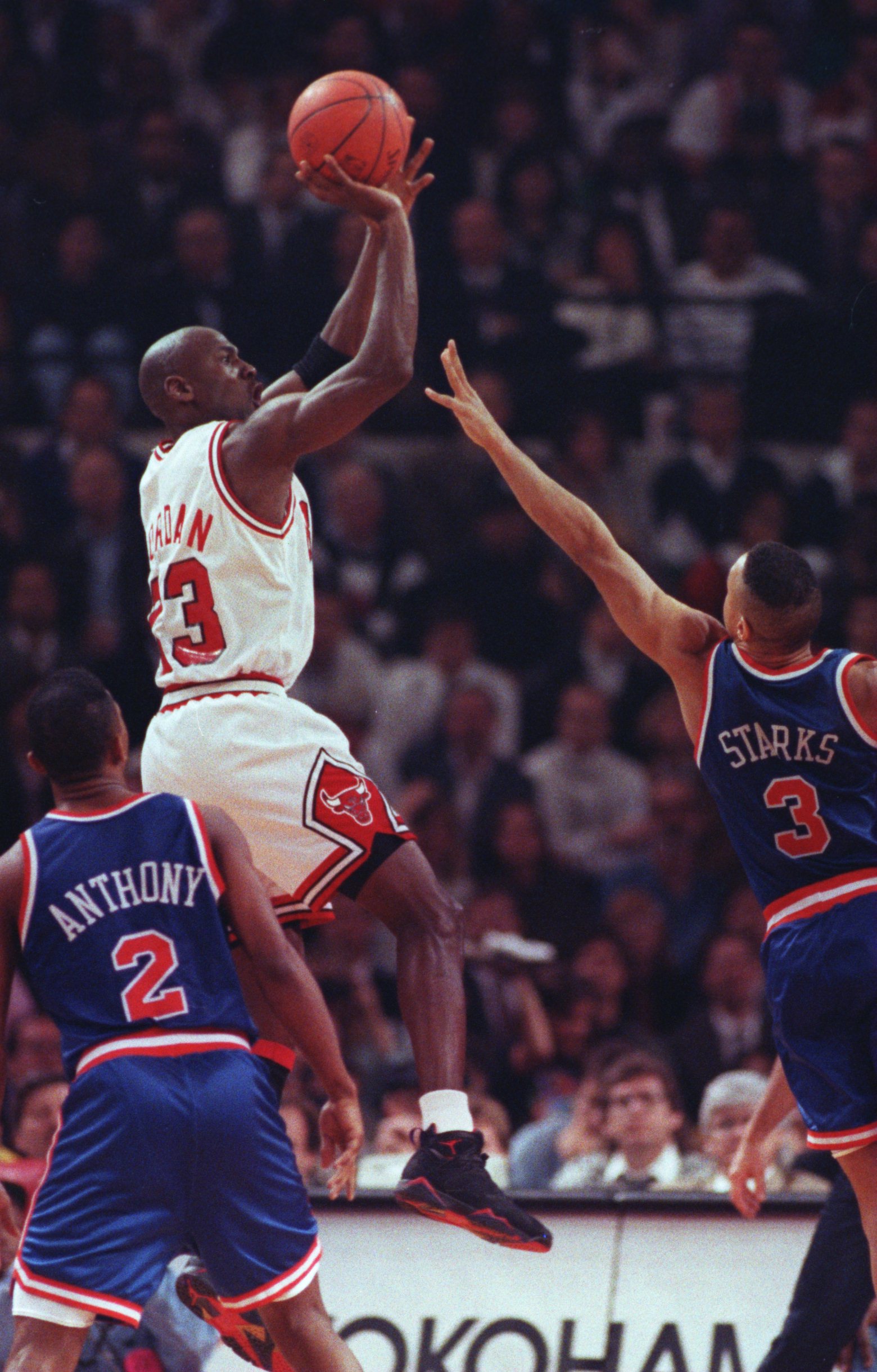5 MAY 1992:  MICHAEL JORDAN OF THE CHICAGO BULLS RISES ABOVE GREG ANTHONY AND JOHN STARKS, BOTH OF THE NEW YORK KNICKS, TO PUT UP A JUMP SHOT DURING THEIR GAME AT CHICAGO STADIUM IN CHICAGO, ILLINOIS. Mandatory Credit: Jonathan Daniel/ALLSPORT