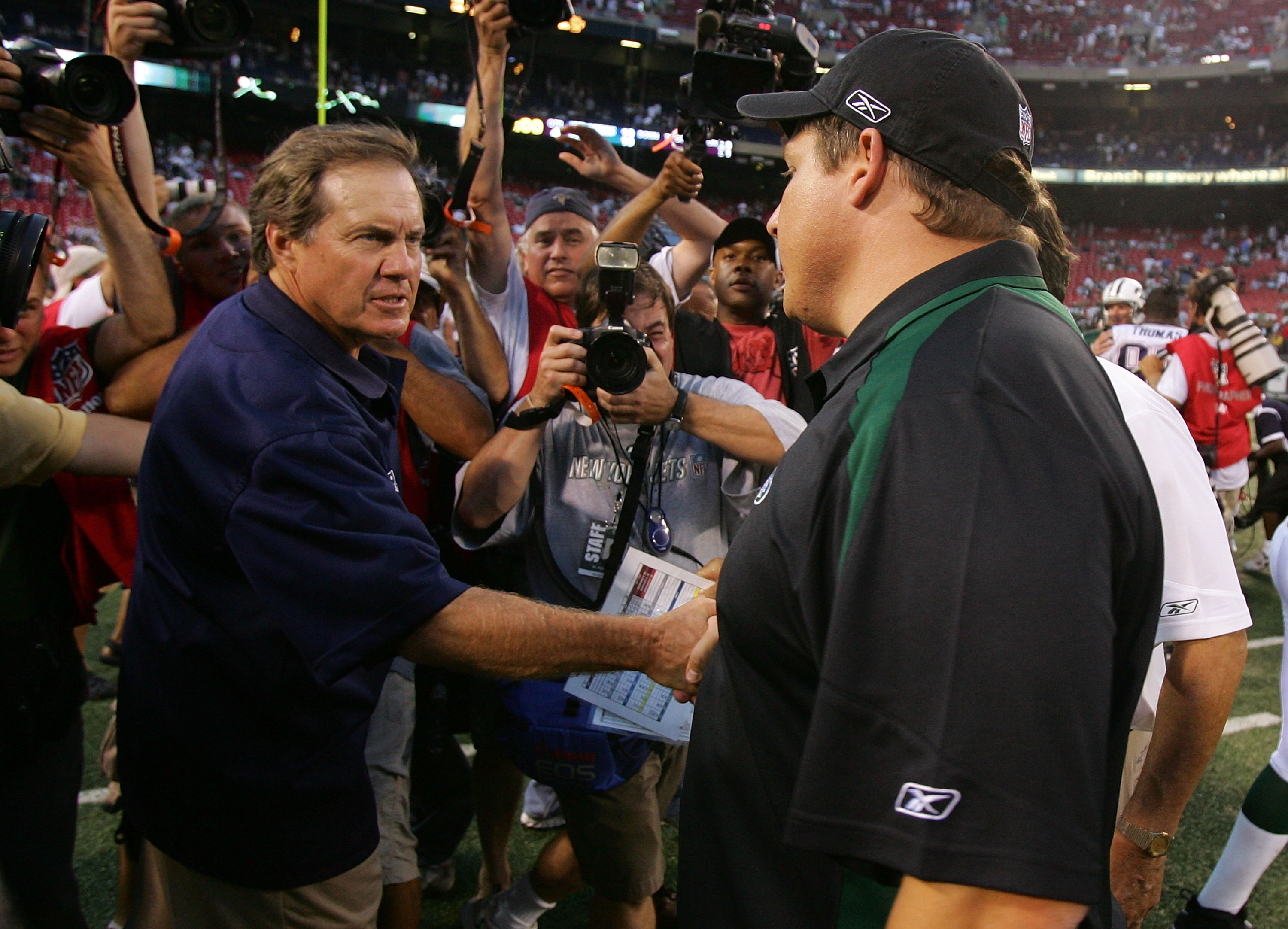 EAST RUTHERFORD, NJ - SEPTEMBER 14: Head coach Eric Mangini (R) of the New York Jets congratulates head coach Bill Belichick of the New England Patriots after their game on September 14, 2008 at Giants Stadium in East Rutherford, New Jersey. The Patriots