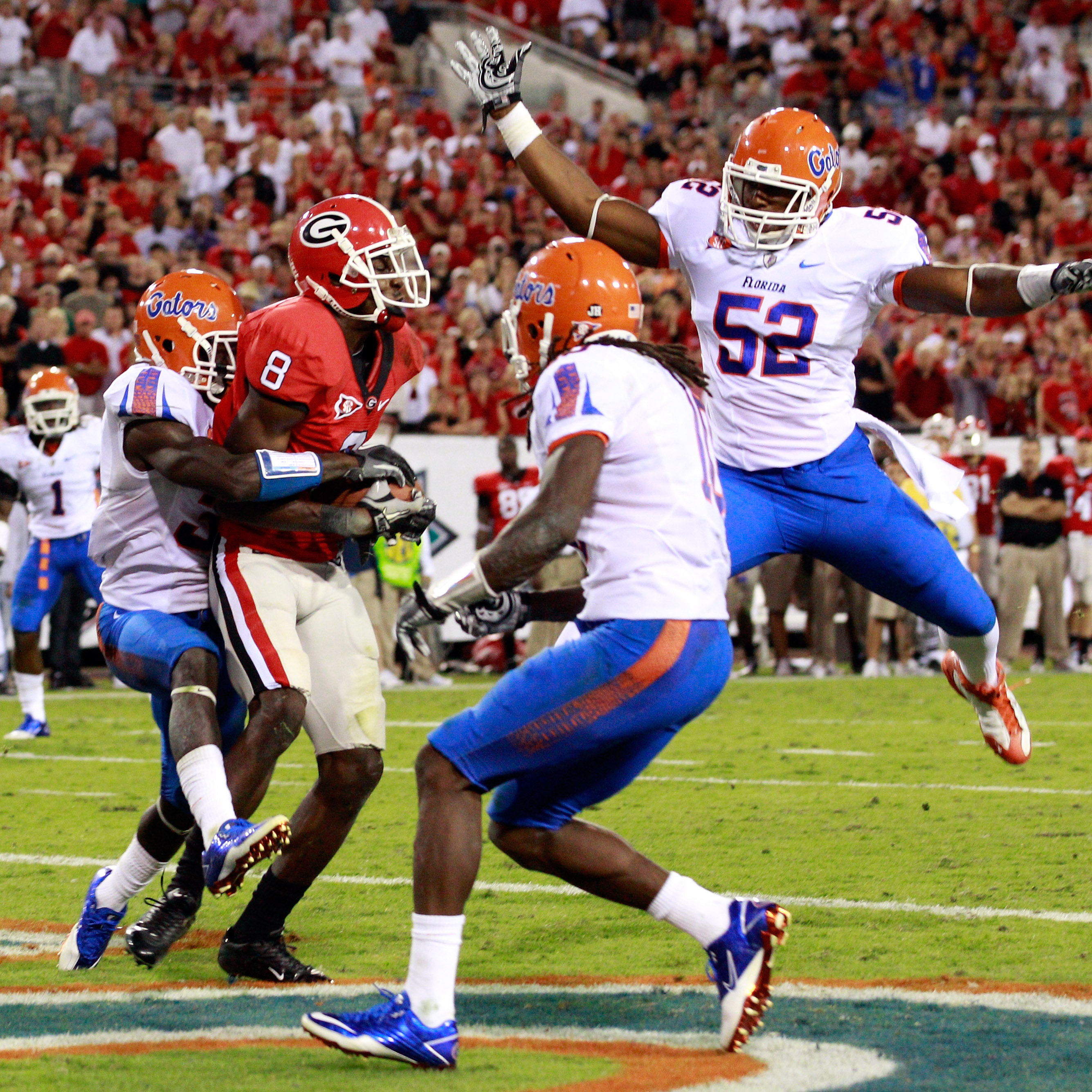 JACKSONVILLE, FL - OCTOBER 30:  A.J. Green #8 of the Georgia Bulldogs catches a pass for a touchdown against Jonathan Bostic #52 of the Florida Gators during the game at EverBank Field on October 30, 2010 in Jacksonville, Florida.  (Photo by Sam Greenwood