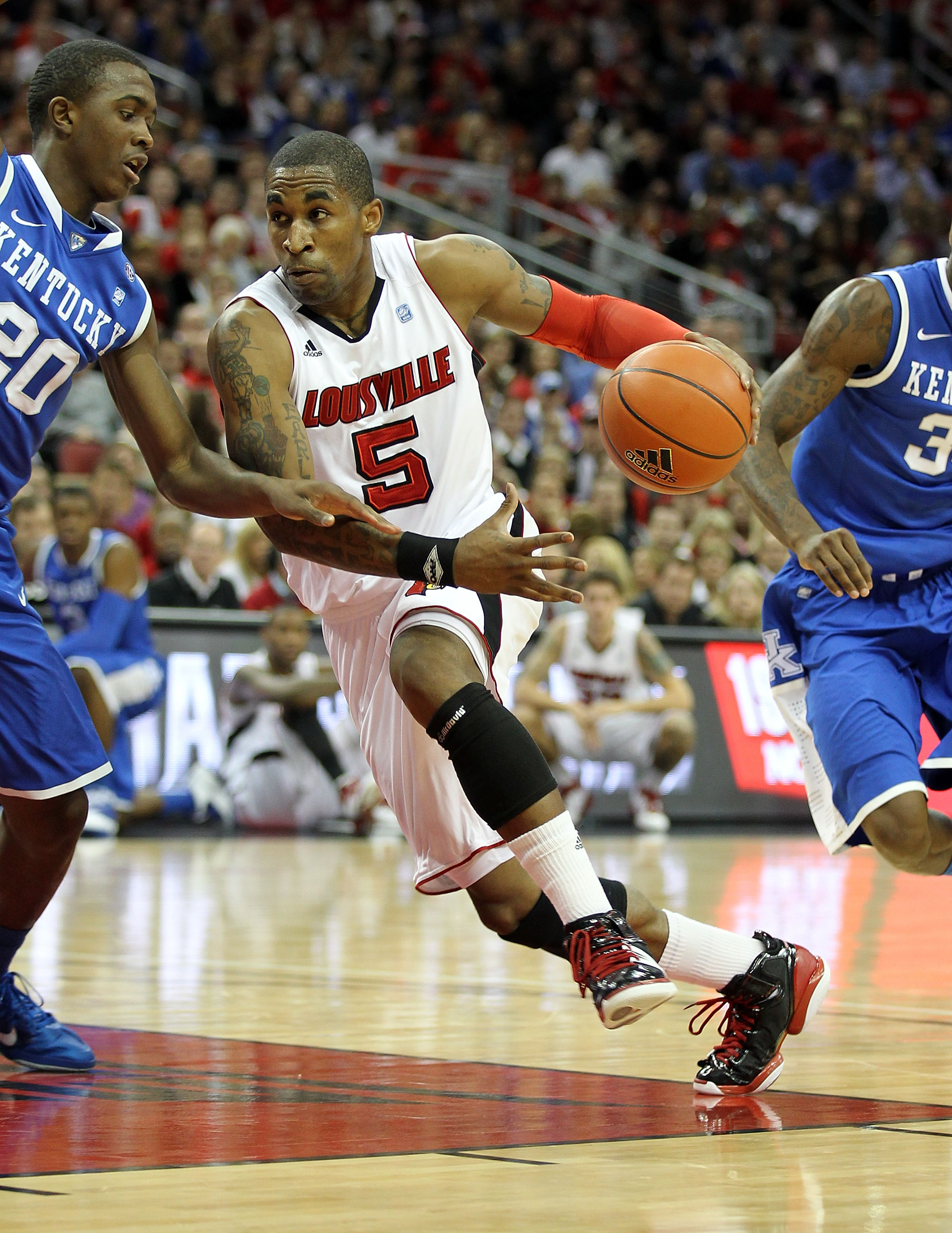 LOUISVILLE, KY - DECEMBER 31:  Chris Smith #5 of the Louisville Cardinals dribbles the ball during the game against the Kentucky Wildcats at the KFC Yum! Center on December 31, 2010 in Louisville, Kentucky. Kentucky won 78-63.  (Photo by Andy Lyons/Getty