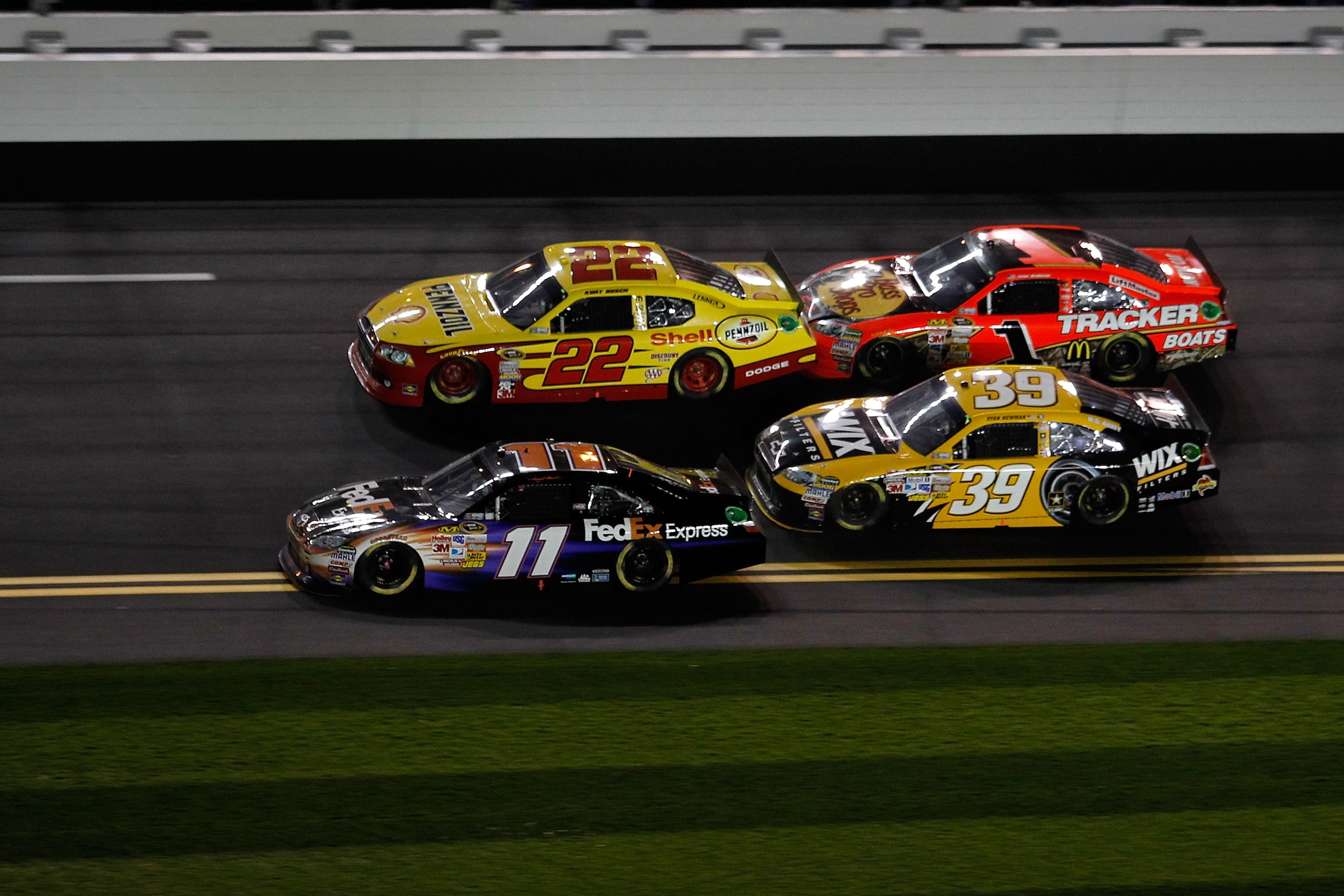 DAYTONA BEACH, FL - FEBRUARY 12:  Denny Hamlin, driver of the #11 FedEx Toyota, crosses the double yellow line to pass resulting in a penalty on the last lap of the NASCAR Budweiser Shootout at Daytona International Speedway on February 12, 2011 in Dayton
