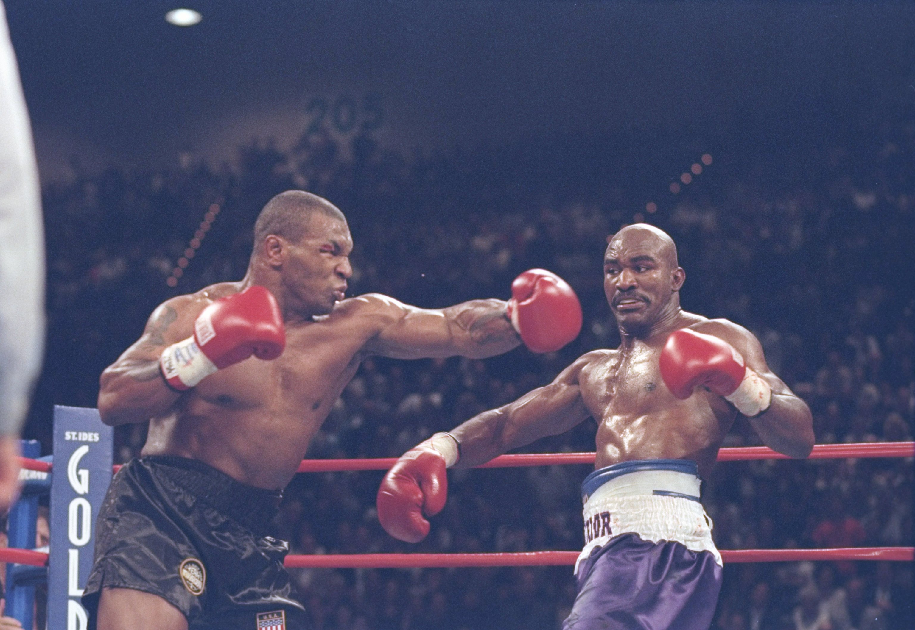 28 Jun 1997: Mike Tyson misses with a left as Evander Holyfield steps aside during their heavyweight title fight at the MGM Grand Garden in Las Vegas, Nevada. Holyfield won the fight when referee Mills Lane disqualified Tyson in the third round after biti