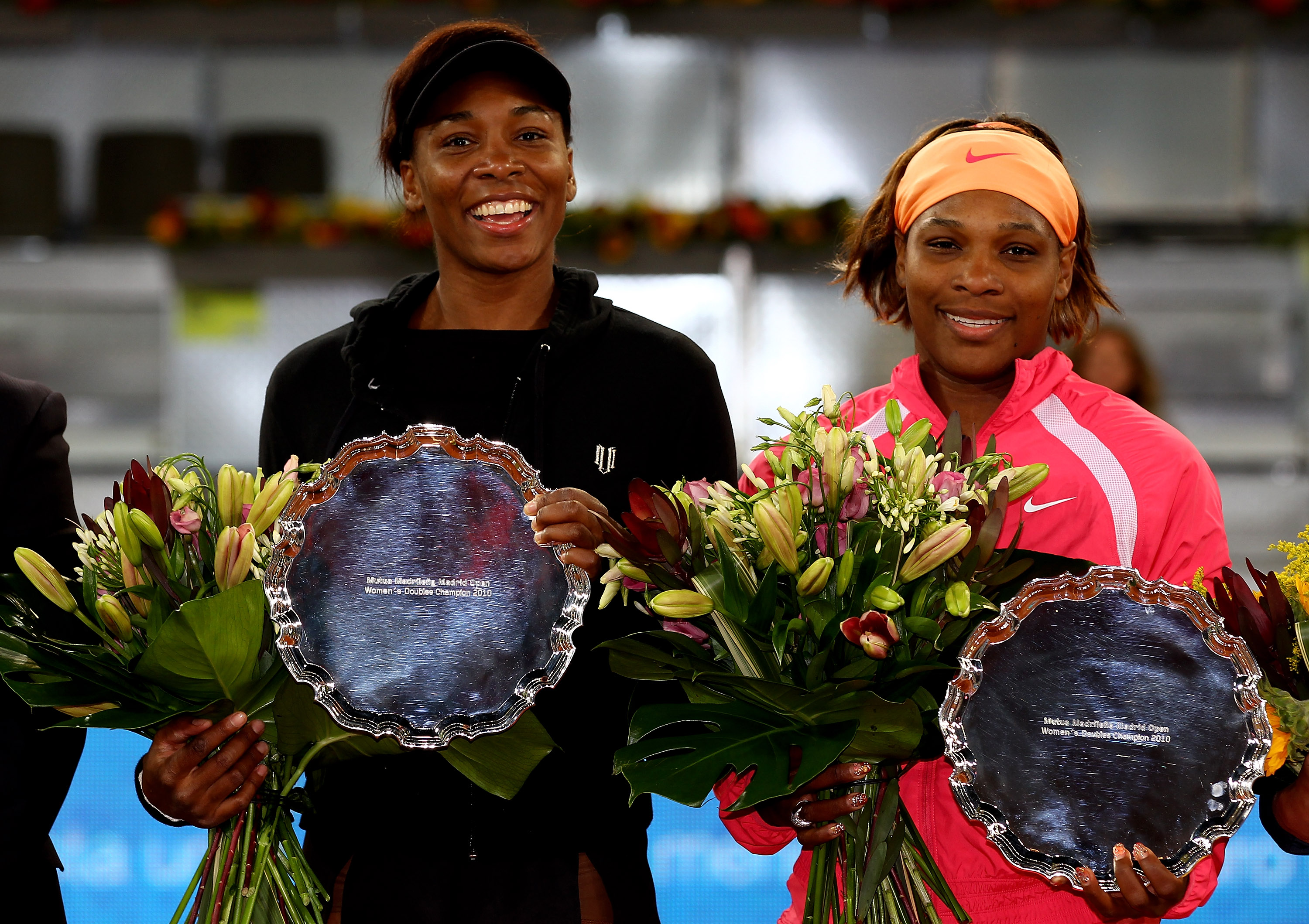 MADRID, SPAIN - MAY 15:  Venus Williams and Serena Williams of the USA hold their trophies after a straight sets victory against Gisela Dulko of Argentina and Flavia Pannetta of Italy in womens doubles final match during the Mutua Madrilena Madrid Open te
