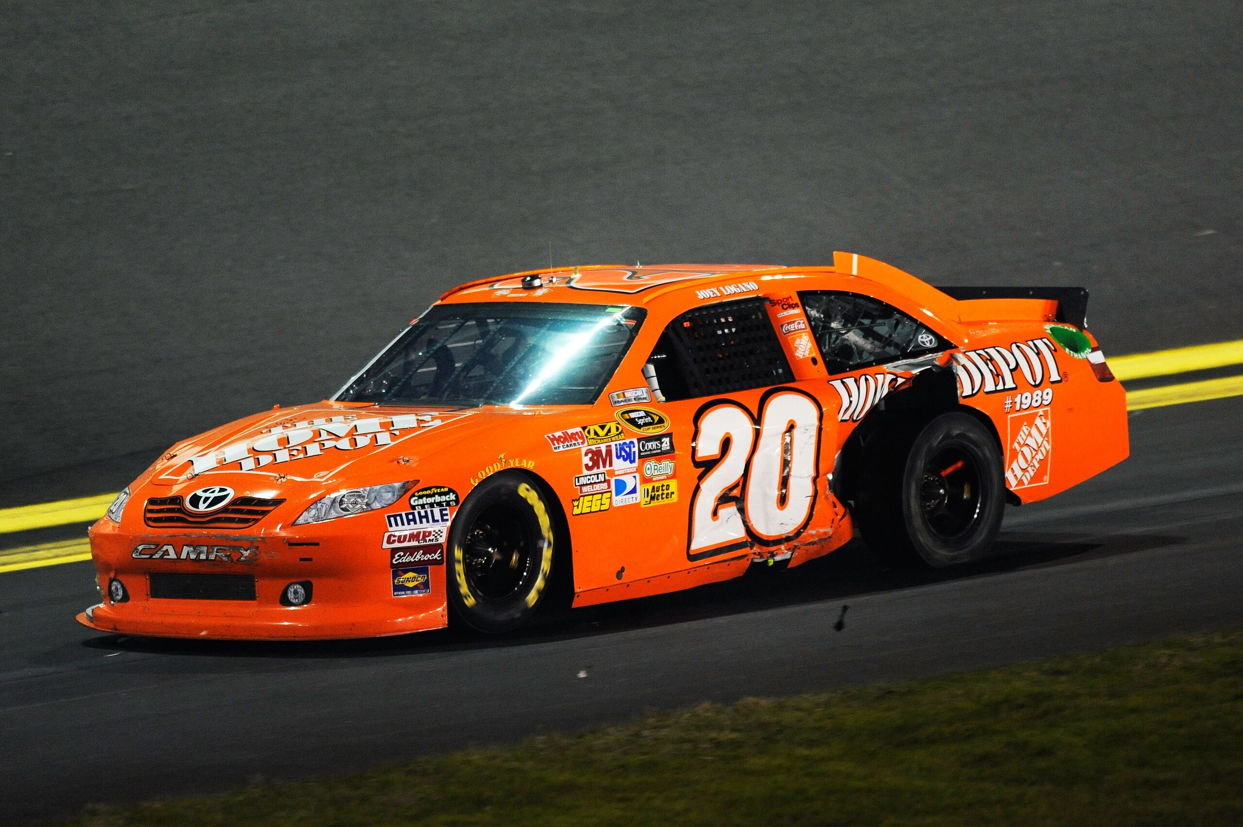 DAYTONA BEACH, FL - FEBRUARY 12:  Joey Logano, driver of the #20 Home Depot Toyota, pulls into pit row after crashing during the NASCAR Budweiser Shootout at Daytona International Speedway on February 12, 2011 in Daytona Beach, Florida.  (Photo by John Ha