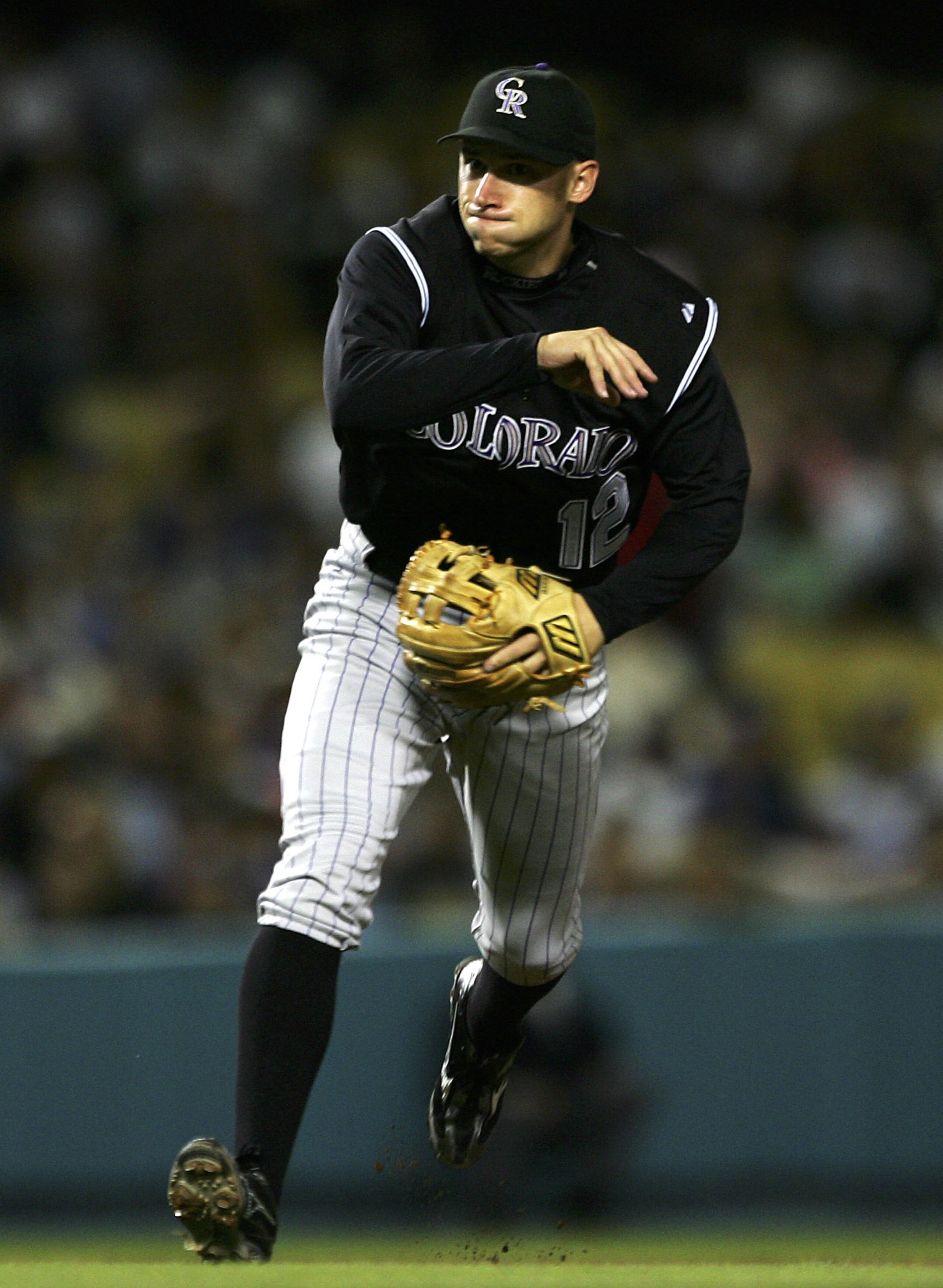 LOS ANGELES - MAY 23:  Clint Barnes #12 of the Colorado Rockies throws to first base and retires Oscar Robles #13 of  the Los Angeles Dodgers during the game on May 23, 2006 at Dodger Stadium in Los Angeles, California.  (Photo by Robert Laberge/Getty Ima