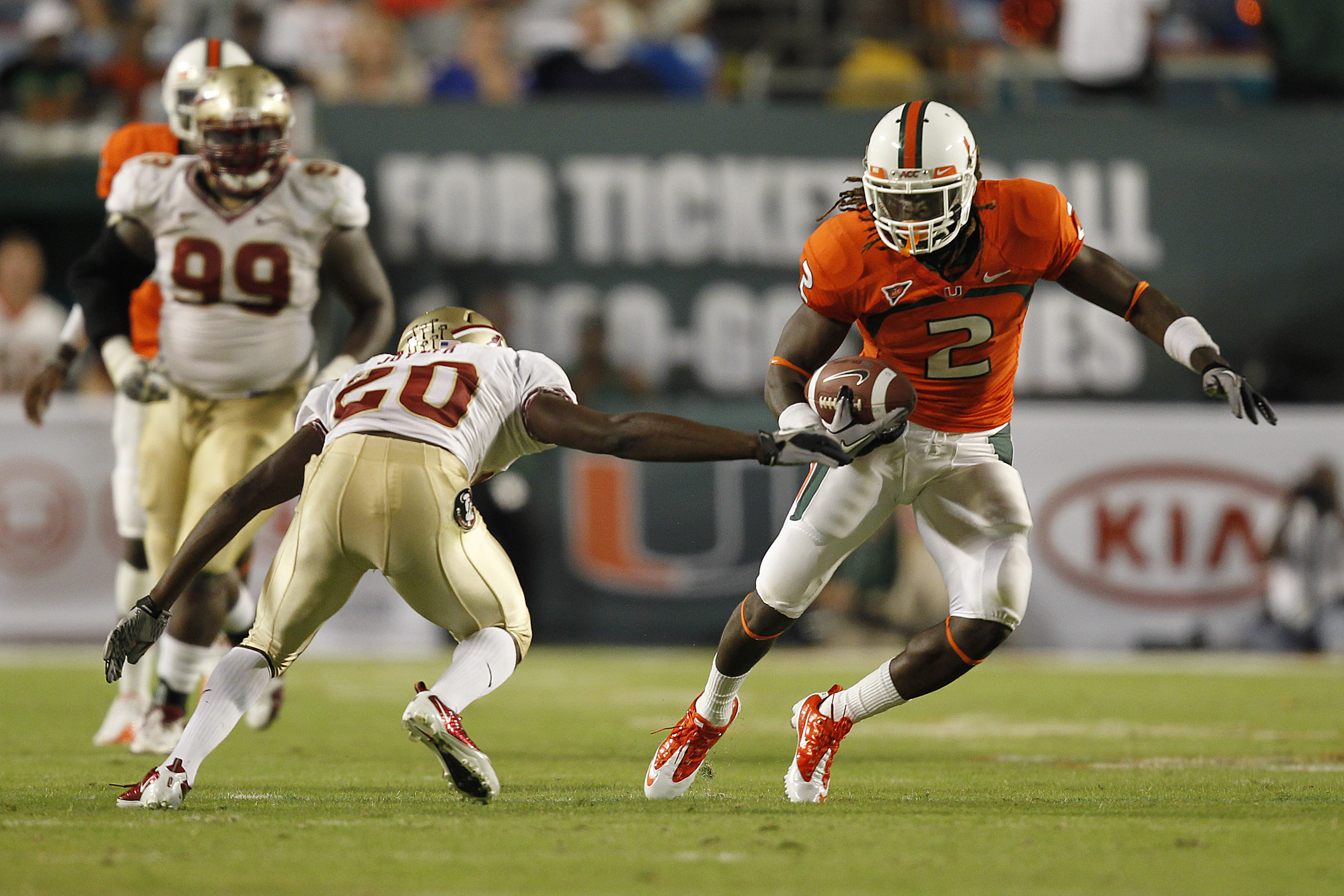 MIAMI, FL - OCTOBER 9: Graig Cooper #2 of the Miami Hurricanes runs with the ball and eludes the tackloe of Lamarcus Joyner #20 of the Florida State Seminoles on October 9, 2010 at Sun Life Stadium in Miami, Florida. (Photo by Joel Auerbach/Getty Images)