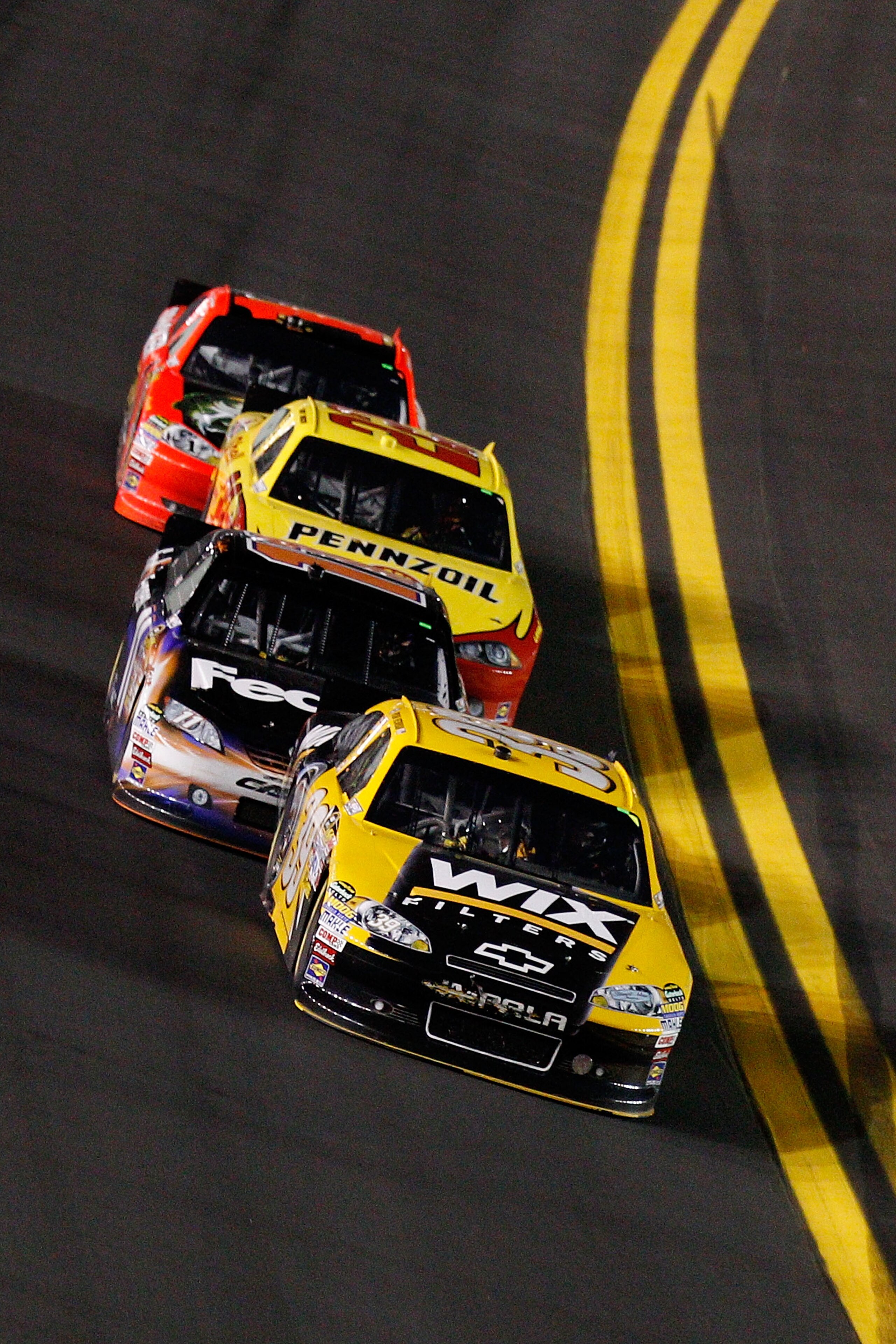 DAYTONA BEACH, FL - FEBRUARY 12:  Ryan Newman, driver of the #39 Wix Chevrolet, leads Denny Hamlin, driver of the #11 FedEx Toyota, Kurt Busch, driver of the #22 Shell/Pennzoil Dodge, and Jamie McMurray, driver of the #1 Bass Pro Shops Chevrolet, during t
