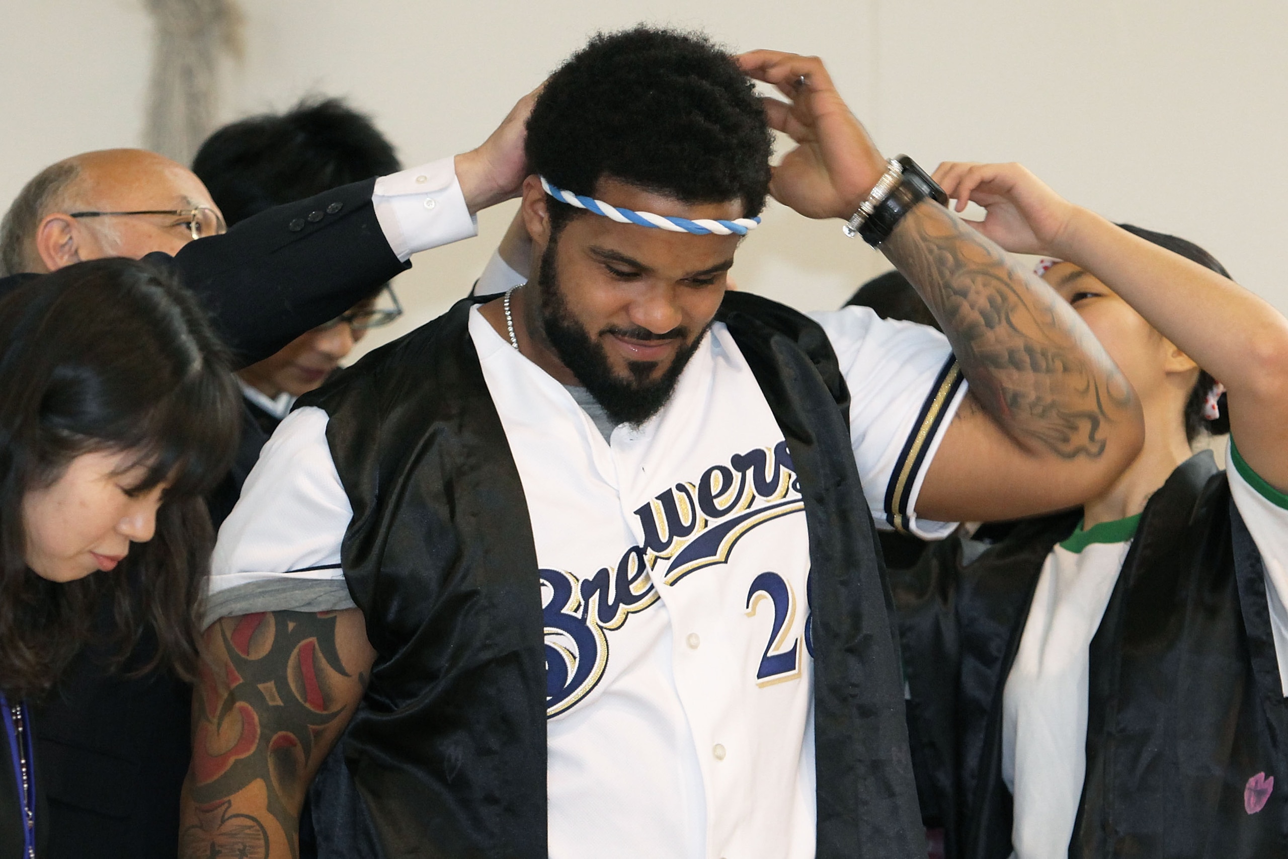 TOKYO - DECEMBER 15:  Prince Fielder of the Milwaukee Brewers wears a hachimaki, or the Japanese headband, as he plays the Japanese drum while visiting Minamisuna Junior High School as part of the Major League Baseball (MLB) International Ambassador progr
