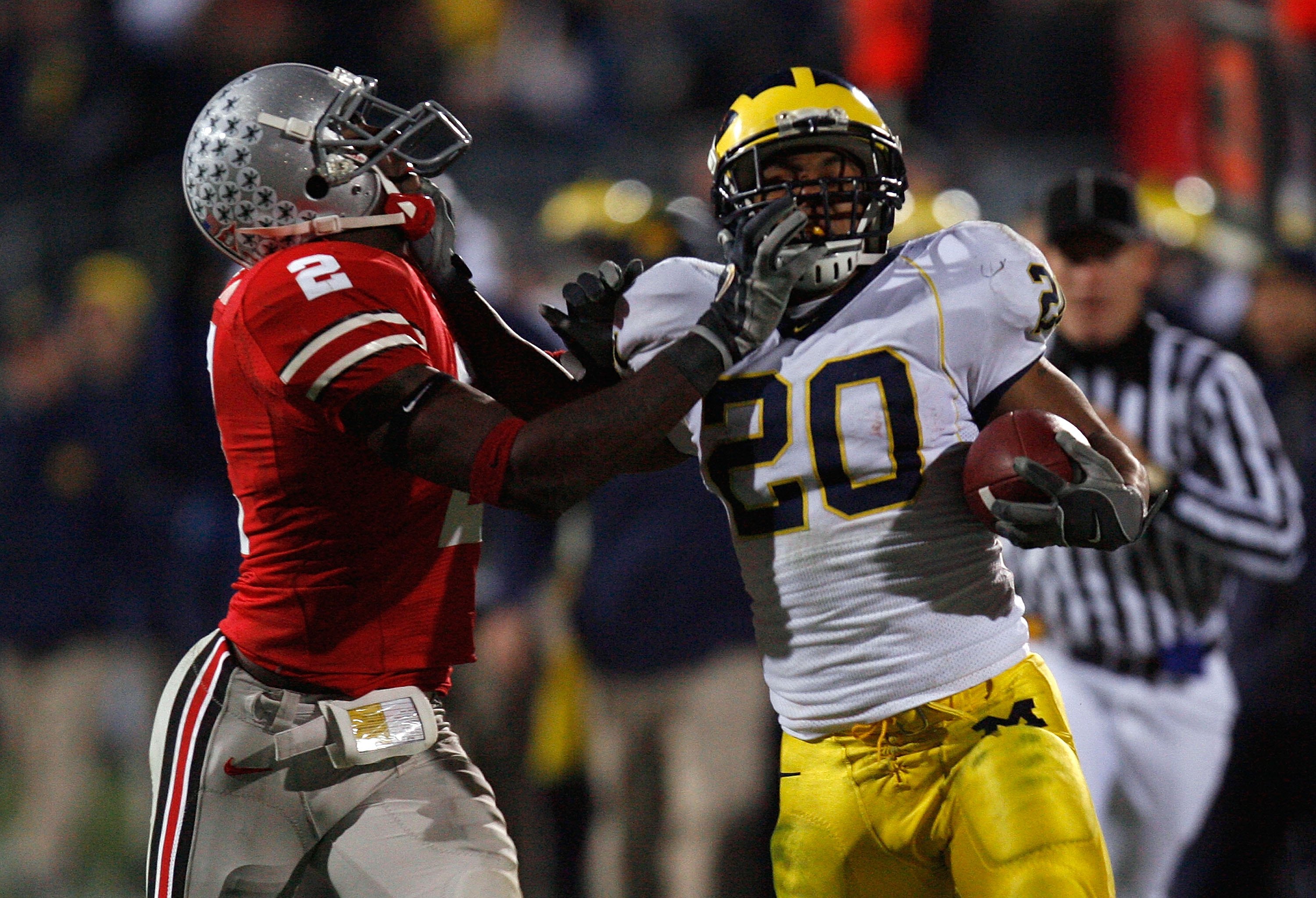 COLUMBUS, OH - NOVEMBER 18:  Mike Hart #20 of the Michigan Wolverines stiff arms Malcolm Jenkins #2 of the Ohio State Buckeyes in the third quarter November 18, 2006 at Ohio Stadium in Columbus, Ohio.  (Photo by Gregory Shamus/Getty Images)