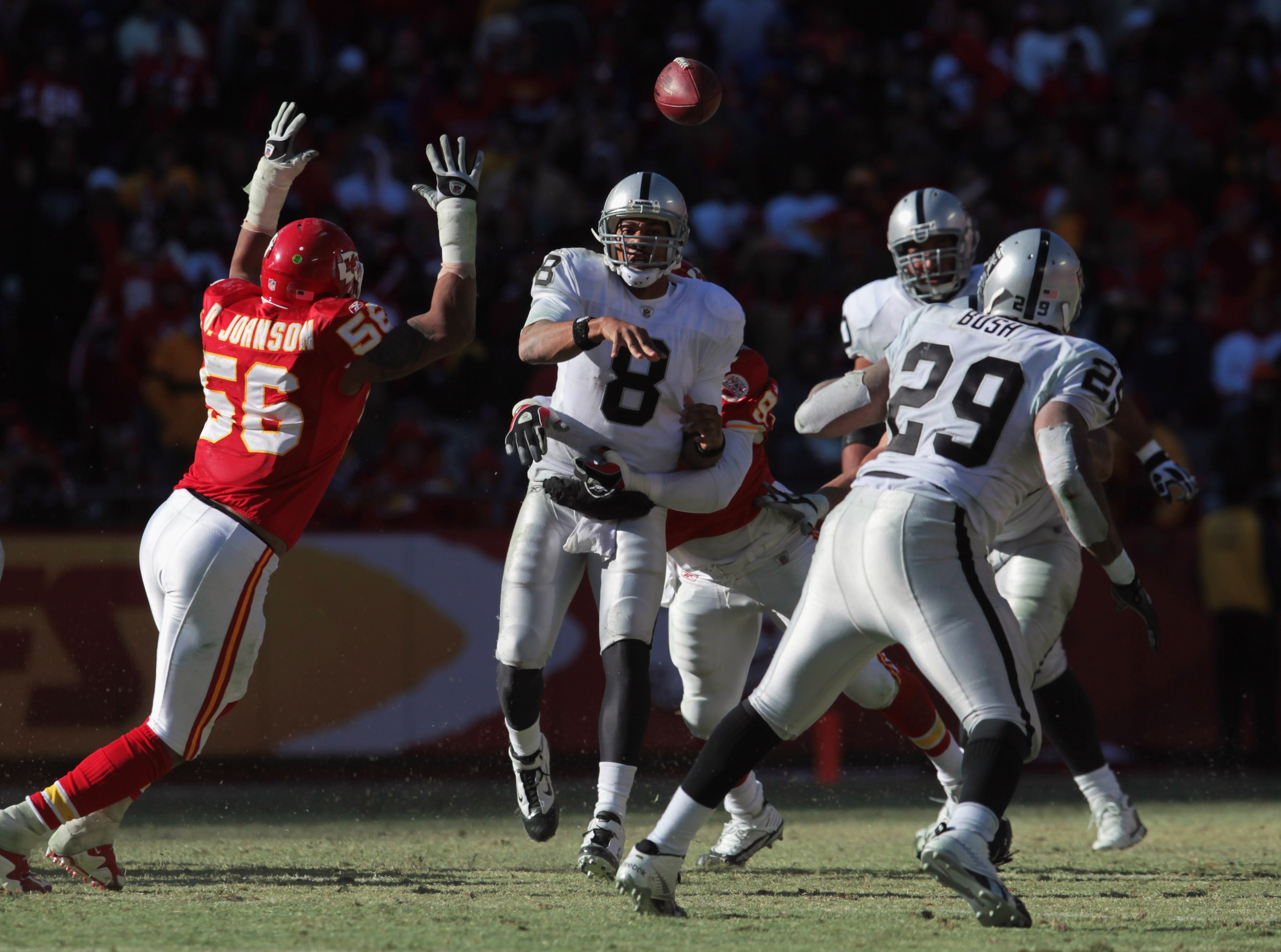 KANSAS CITY, MO - JANUARY 02:  Quarterback Jason Campbell #8 of the Oakland Raiders passes to Michael Bush #29 as Derrick Johnson #56 of the Kansas City Chiefs defends during the game on January 2, 2011 at Arrowhead Stadium in Kansas City, Missouri.  (Pho