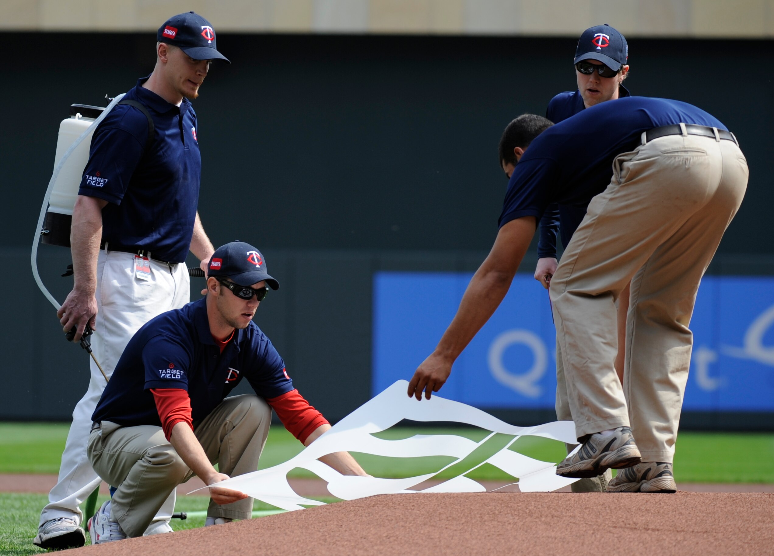 MINNESOTA, MN - APRIL 12: The grounds crew of the Minnesota Twins lay down a logo template on the mound prior to a game between the Minnesota Twins and the Boston Red Sox during the Twins home opener at Target Field on April 12, 2010 in Minneapolis, Minne