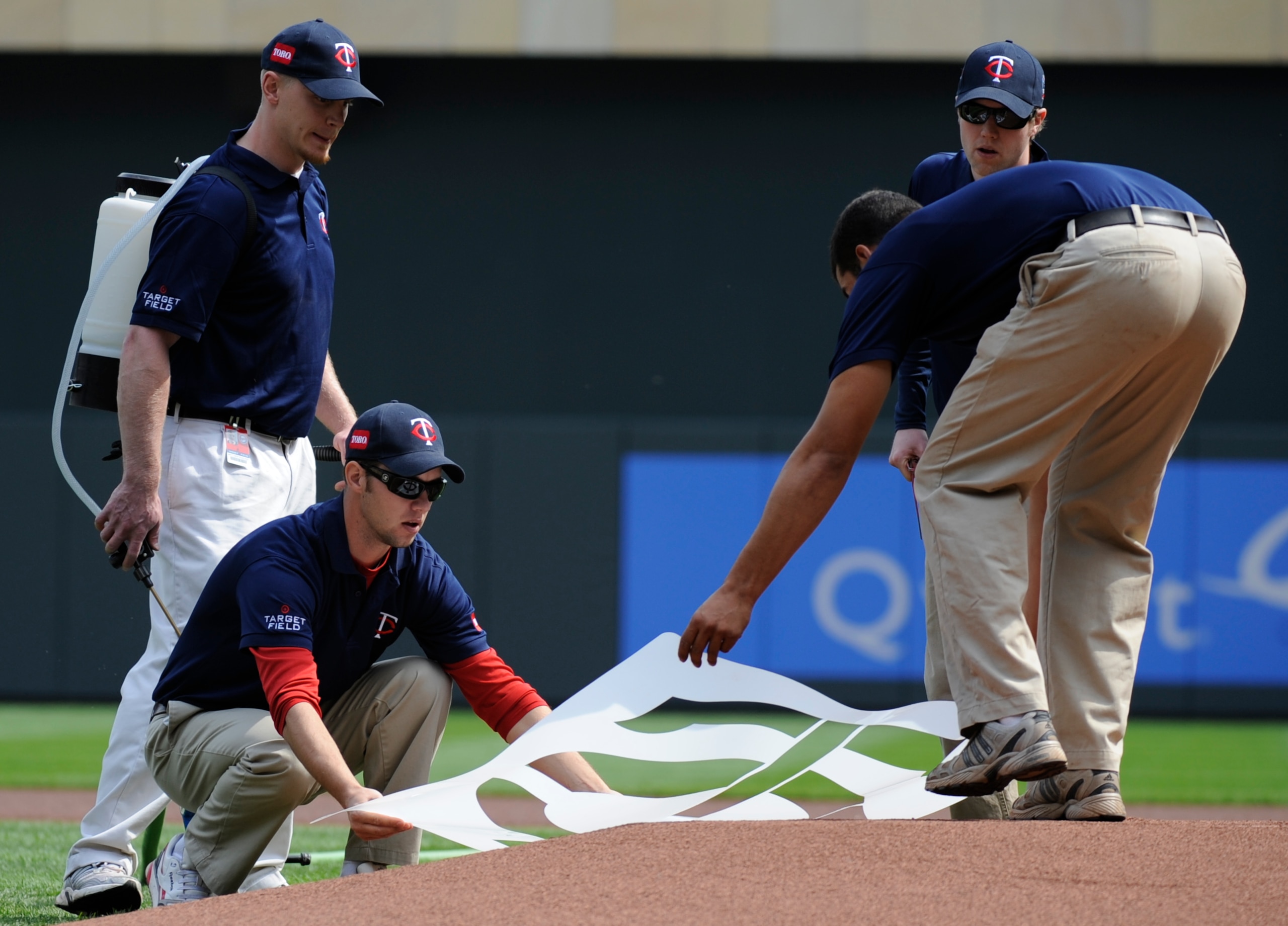 MINNESOTA, MN - APRIL 12: The grounds crew of the Minnesota Twins lay down a logo template on the mound prior to a game between the Minnesota Twins and the Boston Red Sox during the Twins home opener at Target Field on April 12, 2010 in Minneapolis, Minne