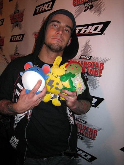 CM Punk holding various Pokemon plushies.