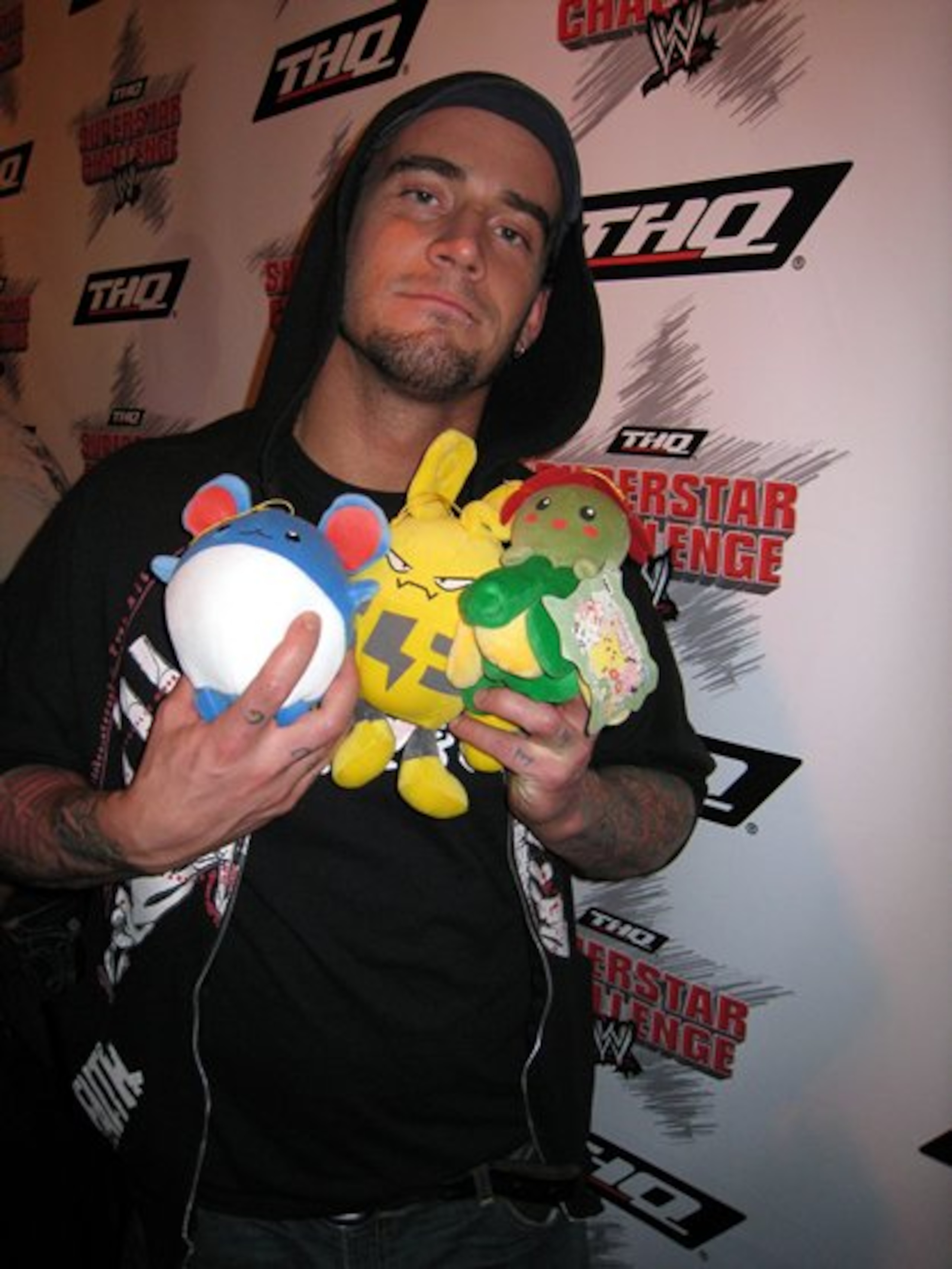 CM Punk holding various Pokemon plushies. CM Punk holding various Pokemon plushies.