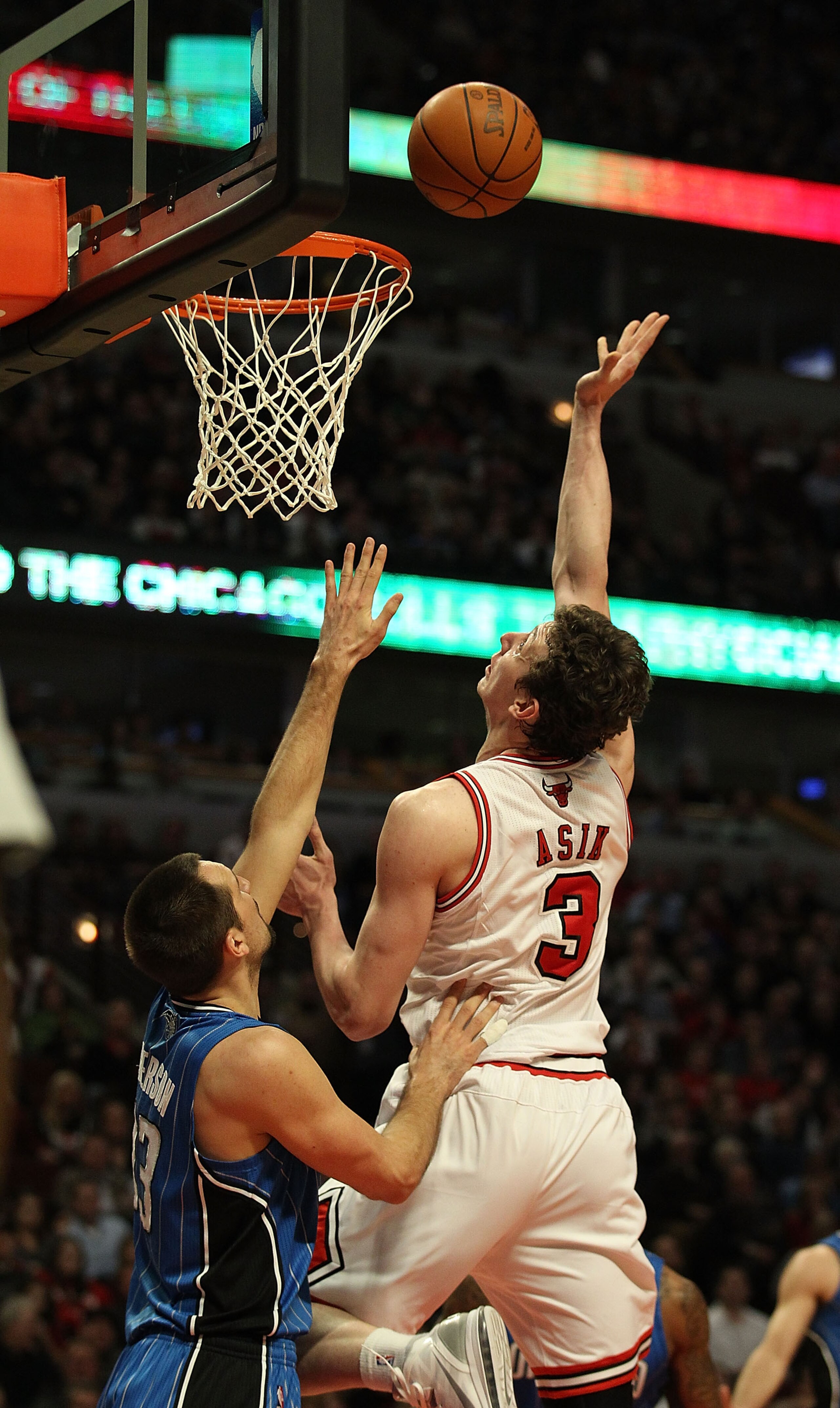 CHICAGO, IL - JANUARY 28: Omer Asik #3 of the Chicago Bulls puts up a shot over Ryan Anderson #33 of the Orlando Magic at the United Center on January 28, 2011 in Chicago, Illinois. The Bulls defeated the Magic 99-90. NOTE TO USER: User expressly acknowle