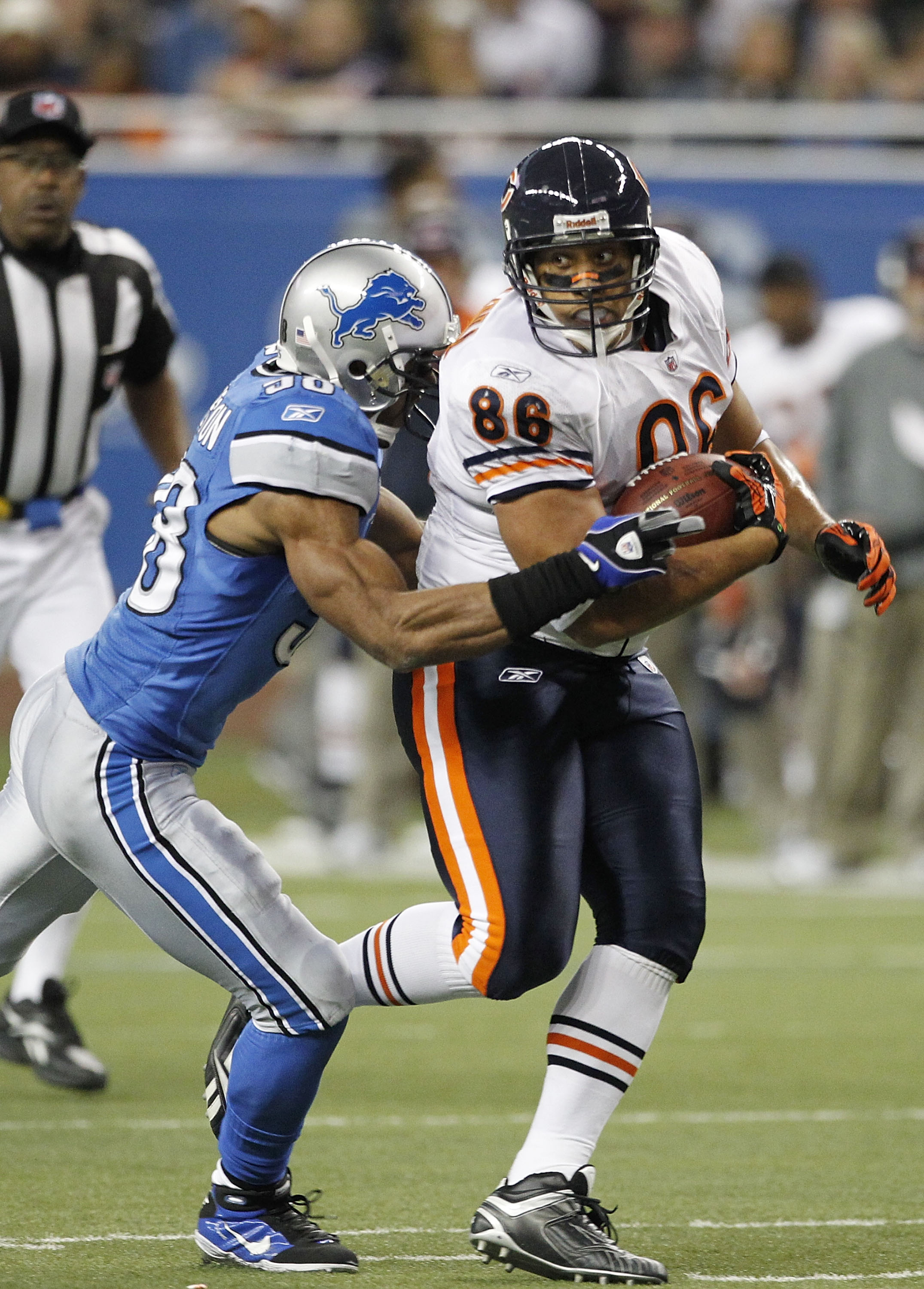 DETROIT - DECEMBER 05:  Brandon Manumaleuna #86 of the Chicago Bears runs for a first down as Julian Peterson #98 of the Detroit Lions makes the tackle during the game at Ford Field on December 5, 2010 in Detroit, Michigan. The Bears defeated the Lions 24