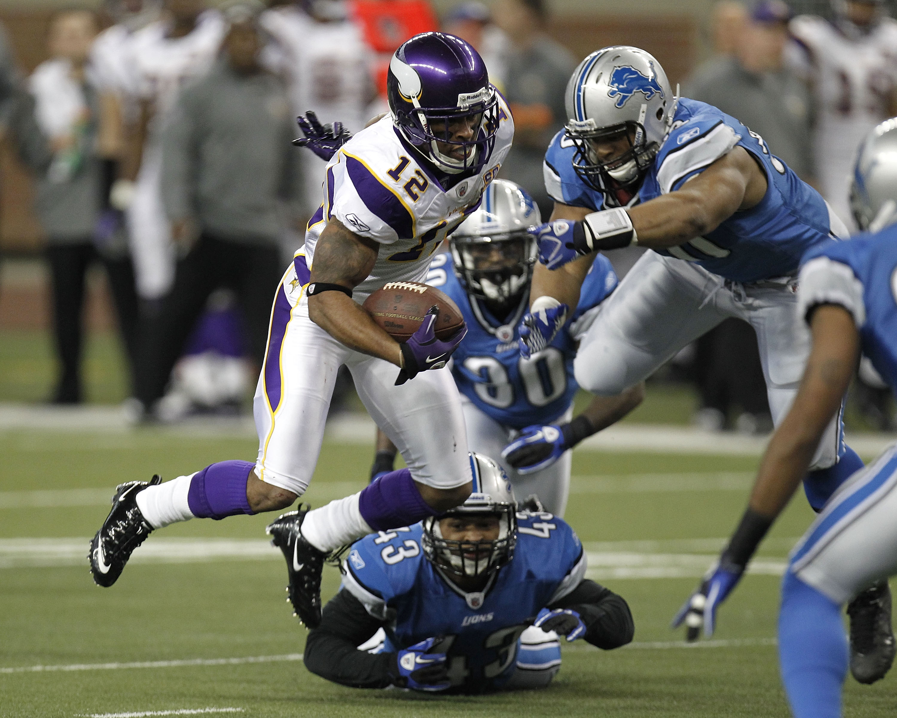 DETROIT, MI - JANUARY 02: Percy Harvin #12 of the Minnesota Vikings tries to escape the tackles of Ndamukong Suh #90, Nathan Vasher #30 and Eric King #43 of the Detroit Lions at Ford Field on January 2, 2011 in Detroit, Michigan.  (Photo by Gregory Shamus