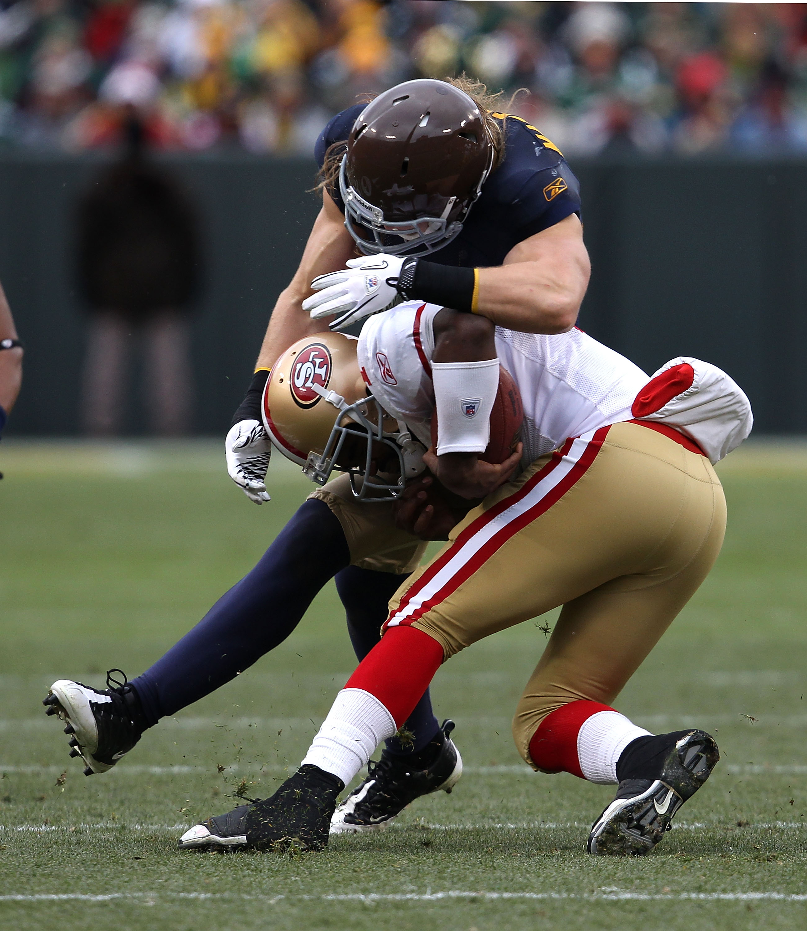 GREEN BAY, WI - DECEMBER 05: Troy Smith #1 of the San Francisco 49ers is tackled by Clay Matthews #52 of the Green Bay Packers at Lambeau Field on December 5, 2010 in Green Bay, Wisconsin. The Packers defeated the 49ers 34-16. (Photo by Jonathan Daniel/Ge