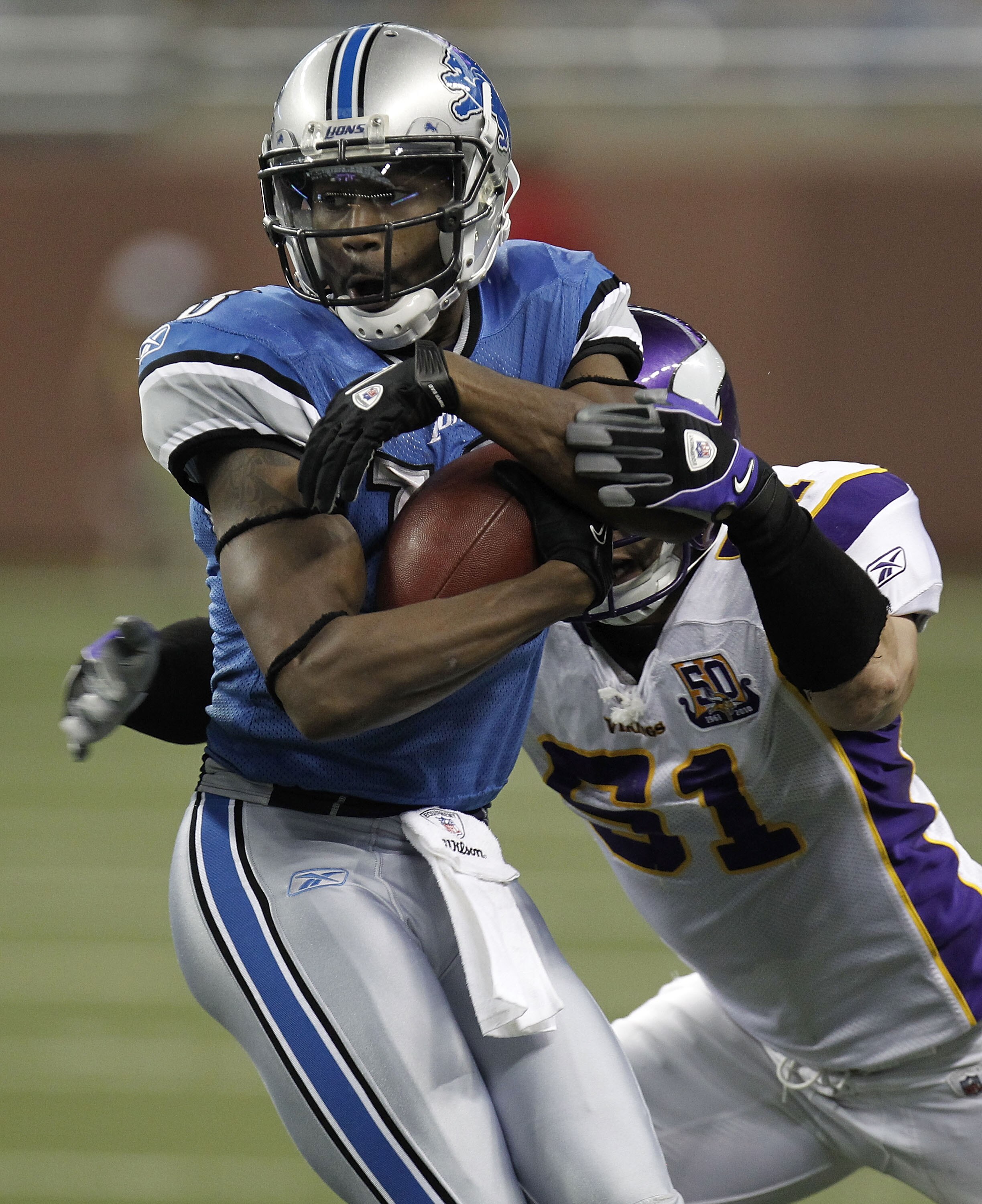 DETROIT, MI - JANUARY 02:  Nate Burleson #13 of the Detroit Lions tries to get past the tackle of Ben Leber #51 of the Minnesota Vikings at Ford Field on January 2, 2011 in Detroit, Michigan.  (Photo by Gregory Shamus/Getty Images)