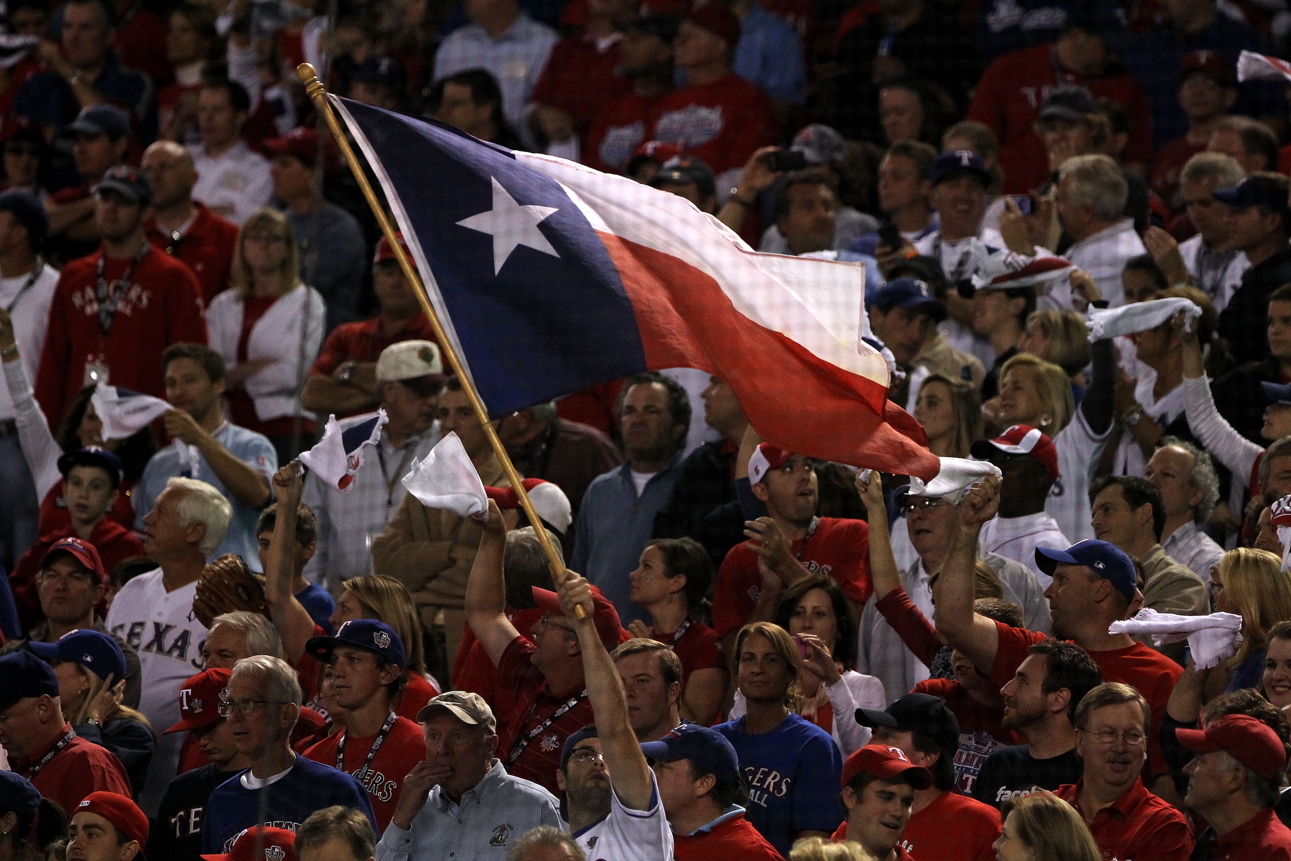 ARLINGTON, TX - NOVEMBER 01:  A fan waves a Texas state flag while the Texas Rangers play against the San Francisco Giants in Game Five of the 2010 MLB World Series at Rangers Ballpark in Arlington on November 1, 2010 in Arlington, Texas.  (Photo by Doug 