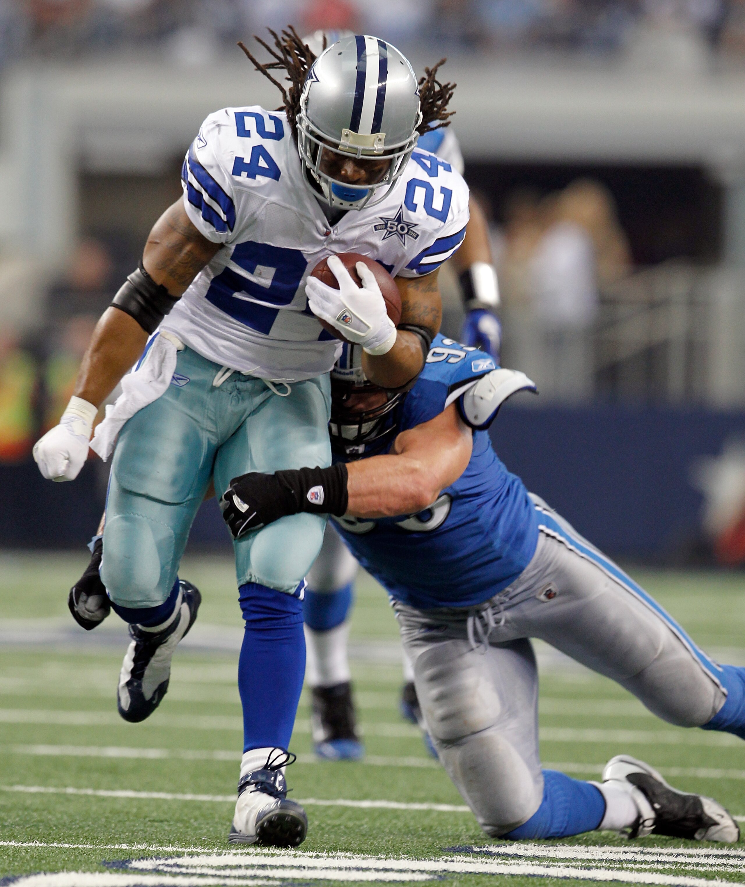 ARLINGTON, TX - NOVEMBER 21:  Running back Marion Barber #24 of the Dallas Cowboys carries the ball against defensive end Kyle Vanden Bosch #93 at Cowboys Stadium on November 21, 2010 in Arlington, Texas. The Cowboys beat the Lions 35-19.  (Photo by Tom P