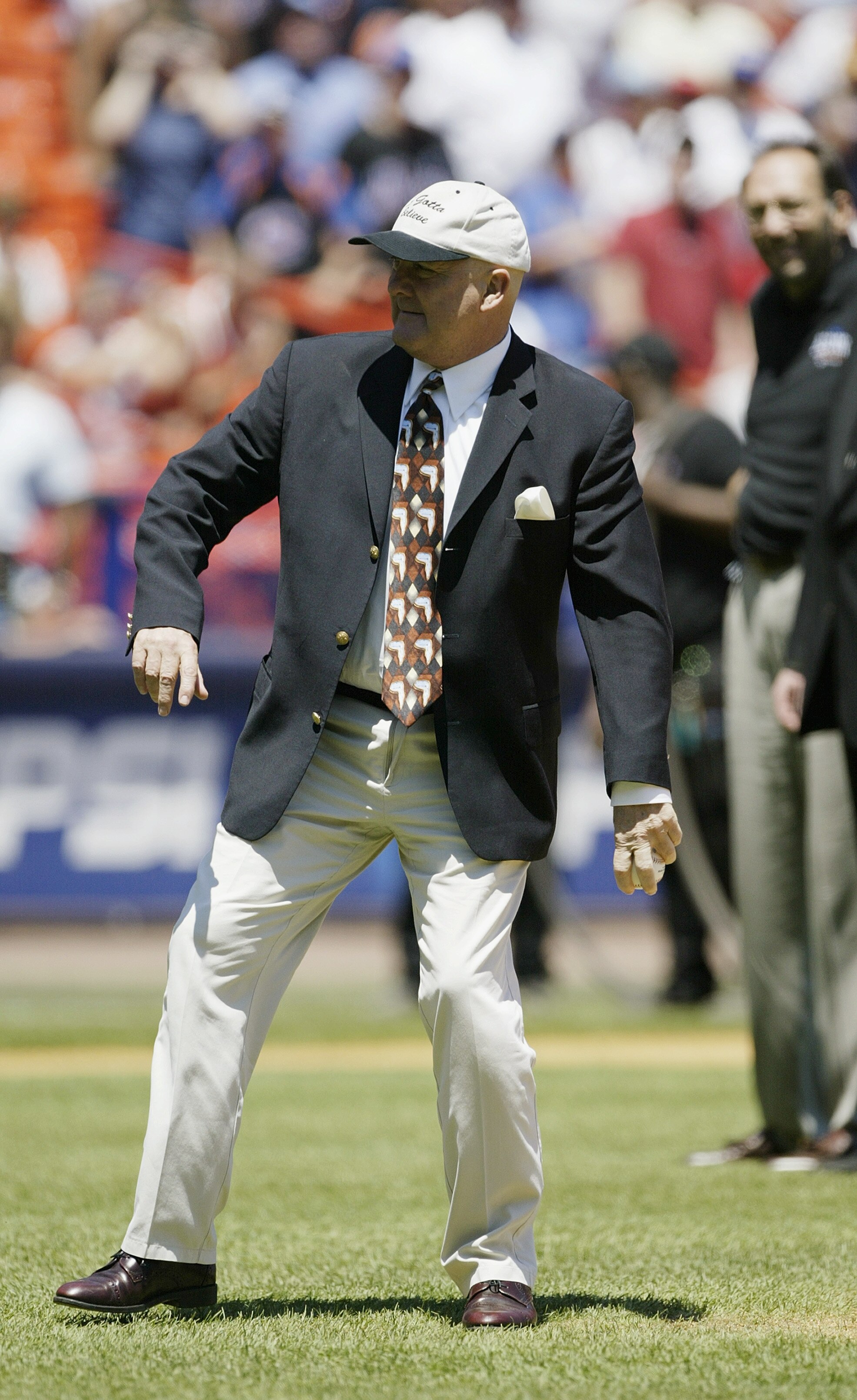 FLUSHING, NY - JULY 13:  Tug McGraw a member of the 1973 New York Mets throws out the first pitch prior to the National League game between the New York Mets and the Philadelphia Phillies at Shea Stadium on July 13, 2003 in Flushing, New York. The Mets wo