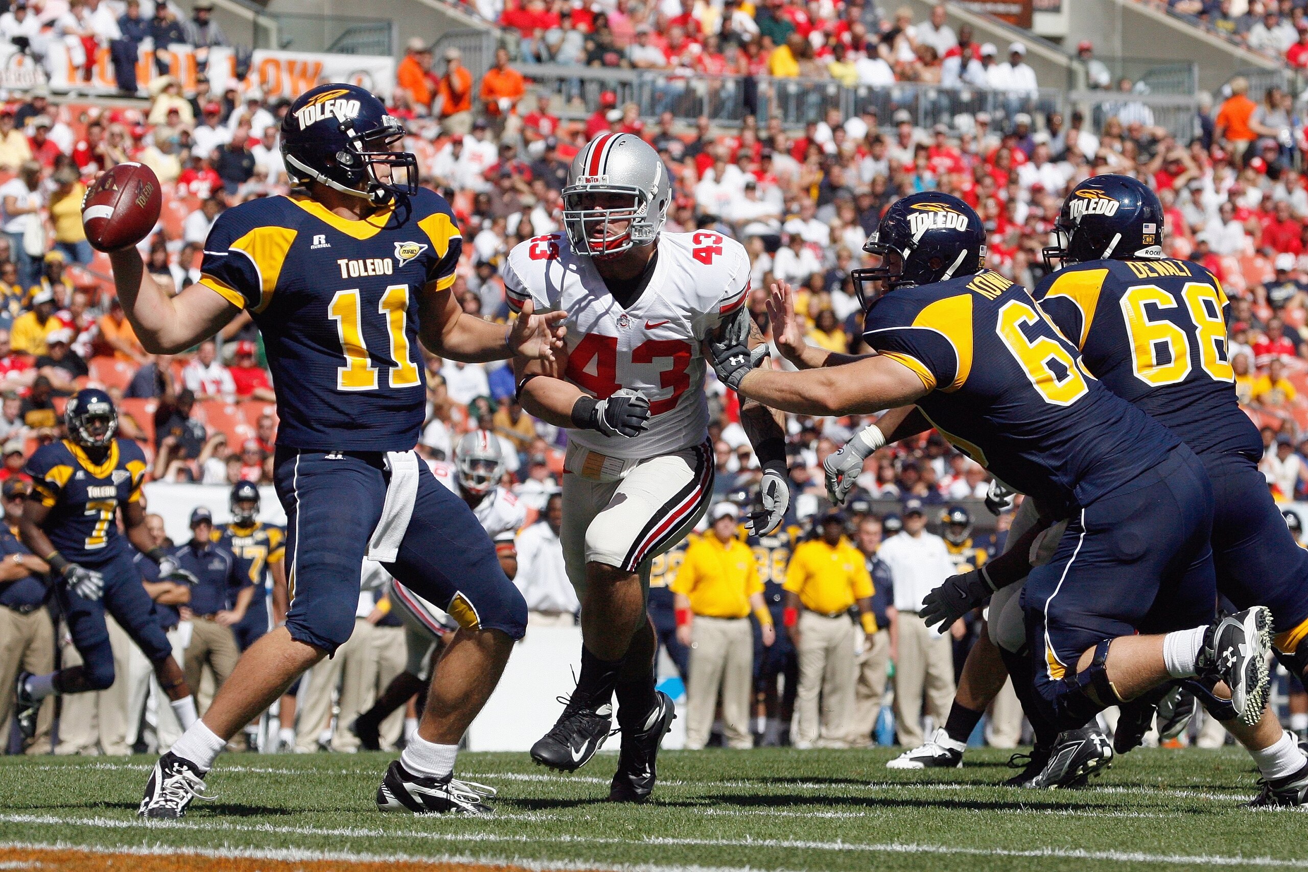 CLEVELAND - SEPTEMBER 19: Nathan Williams #43 of the Ohio State Buckeyes rushes quarterback Aaron Opelt #11 of the Toledo Rockets at Cleveland Browns Stadium on September 19, 2009 in Cleveland, Ohio. The Ohio State Buckeyes shutout the Toledo Rockets 38-0 CLEVELAND - SEPTEMBER 19: Nathan Williams #43 of the Ohio State Buckeyes rushes quarterback Aaron Opelt #11 of the Toledo Rockets at Cleveland Browns Stadium on September 19, 2009 in Cleveland, Ohio. The Ohio State Buckeyes shutout the Toledo Rockets 38-0