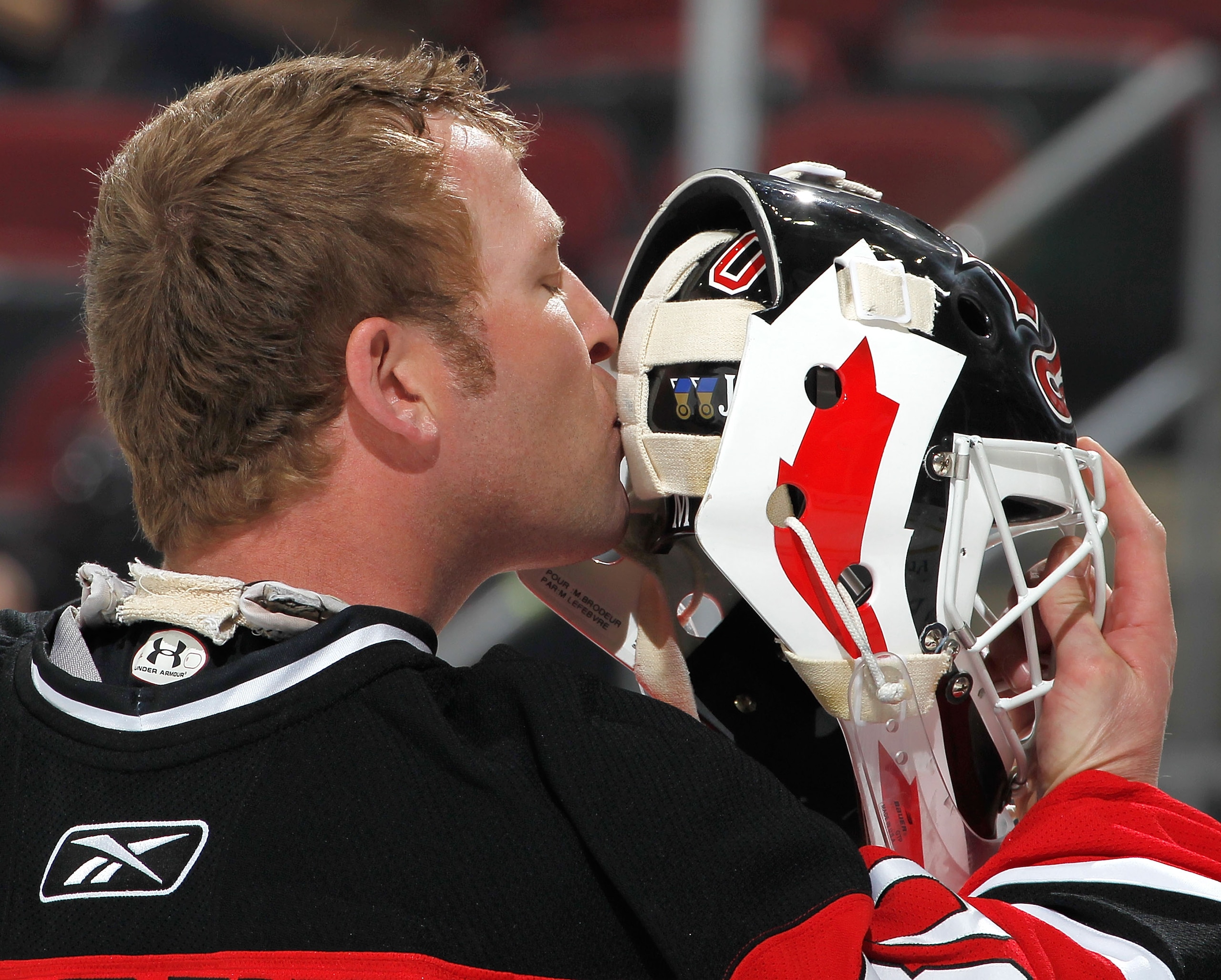 NEWARK, NJ - FEBRUARY 01:  Goalie Martin Brodeur #30 of the New Jersey Devils kisses the back of his mask before the start of an NHL hockey game against the Ottawa Senators at the Prudential Center on February 1, 2011 in Newark, New Jersey.  (Photo by Pau