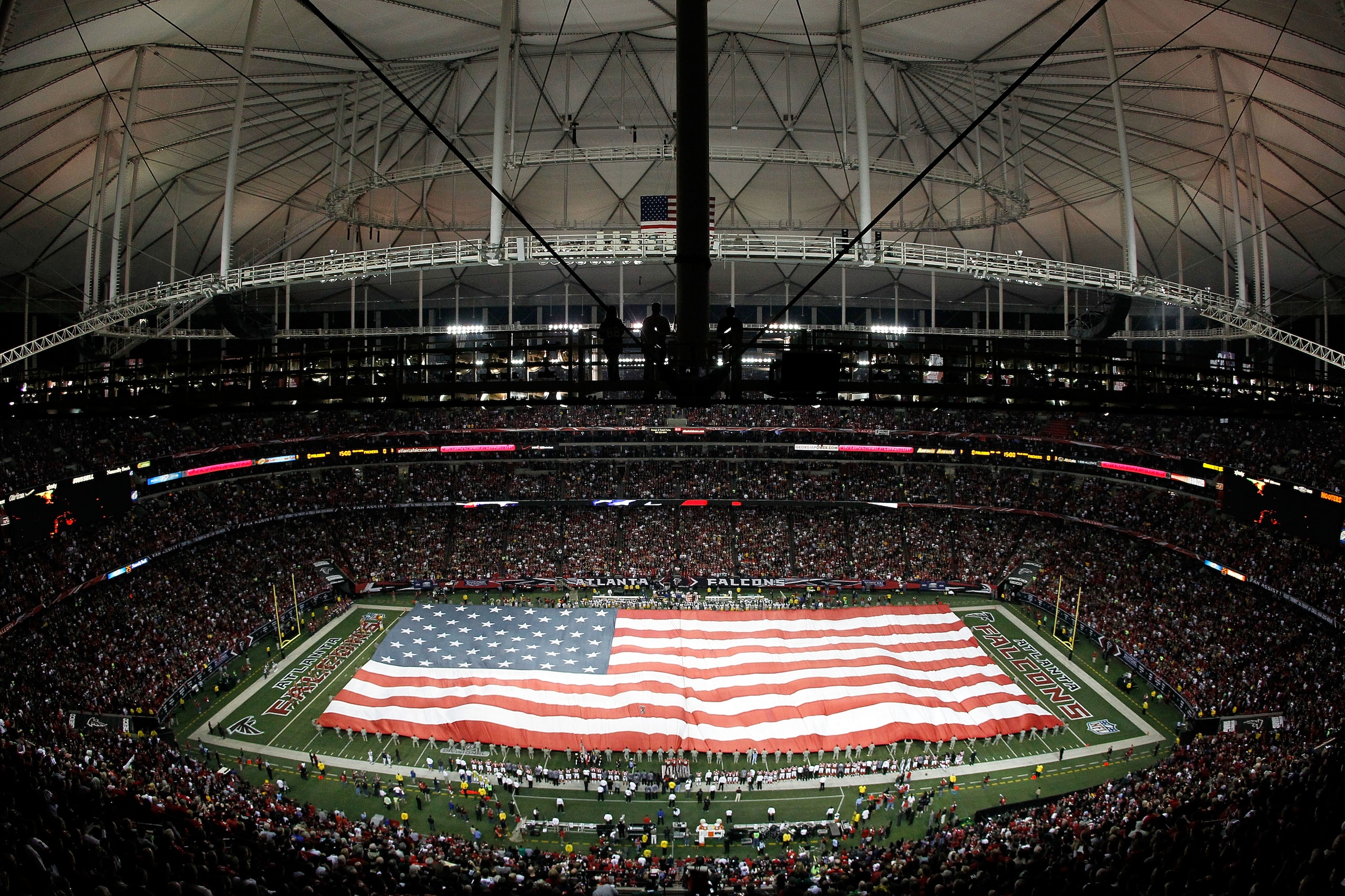 ATLANTA, GA - JANUARY 15:  A general view of a giant American Flag as it's stretched across the field for the performance of the National Anthem prior to the Atlanta Falcons playing against the Green Bay Packers during their 2011 NFC divisional playoff ga
